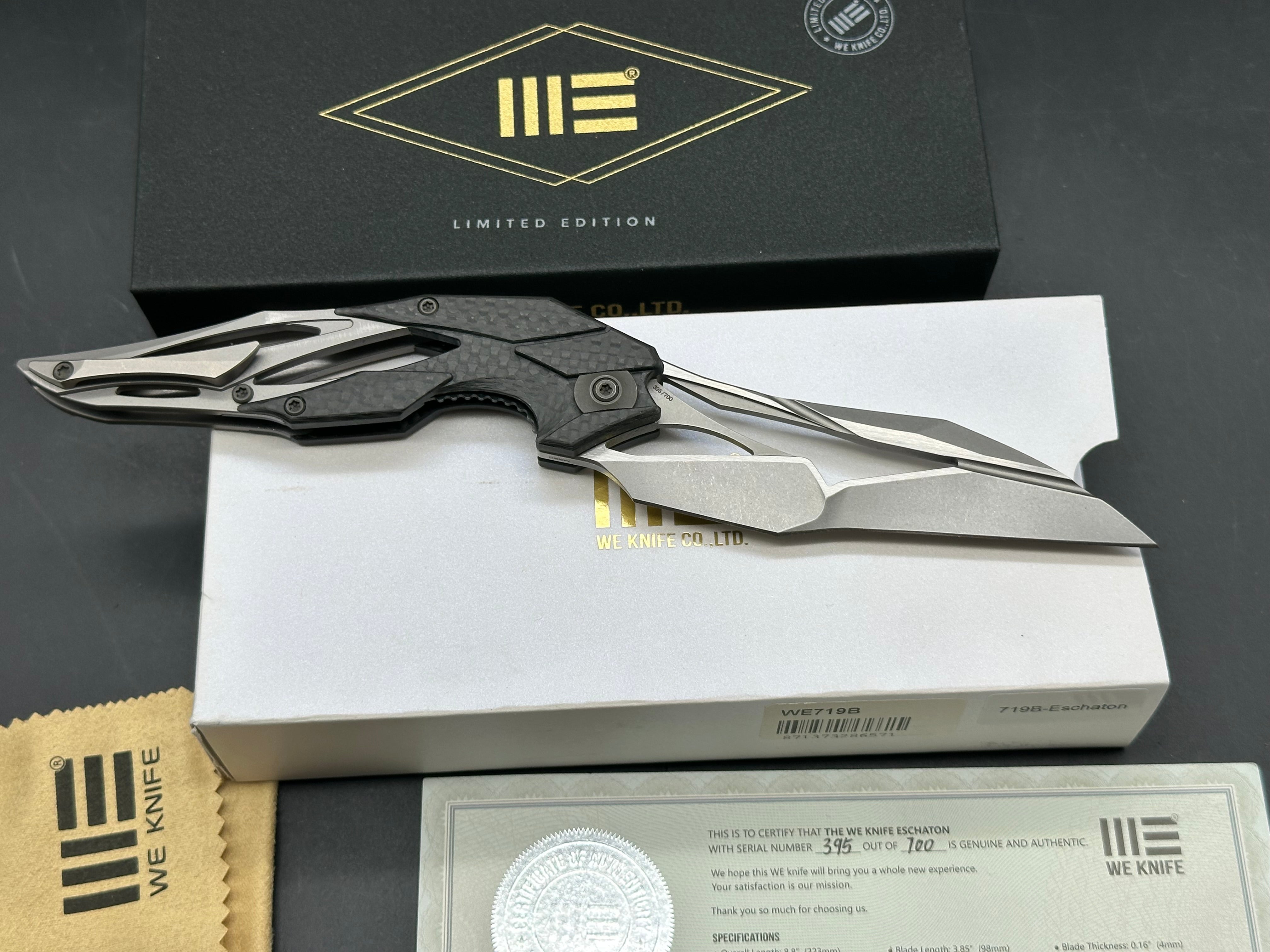 We Eschaton: Elijah Isham design. 3.83 inch, M390, flat grind wharncliffe blade Carbon fiber and titanium handle