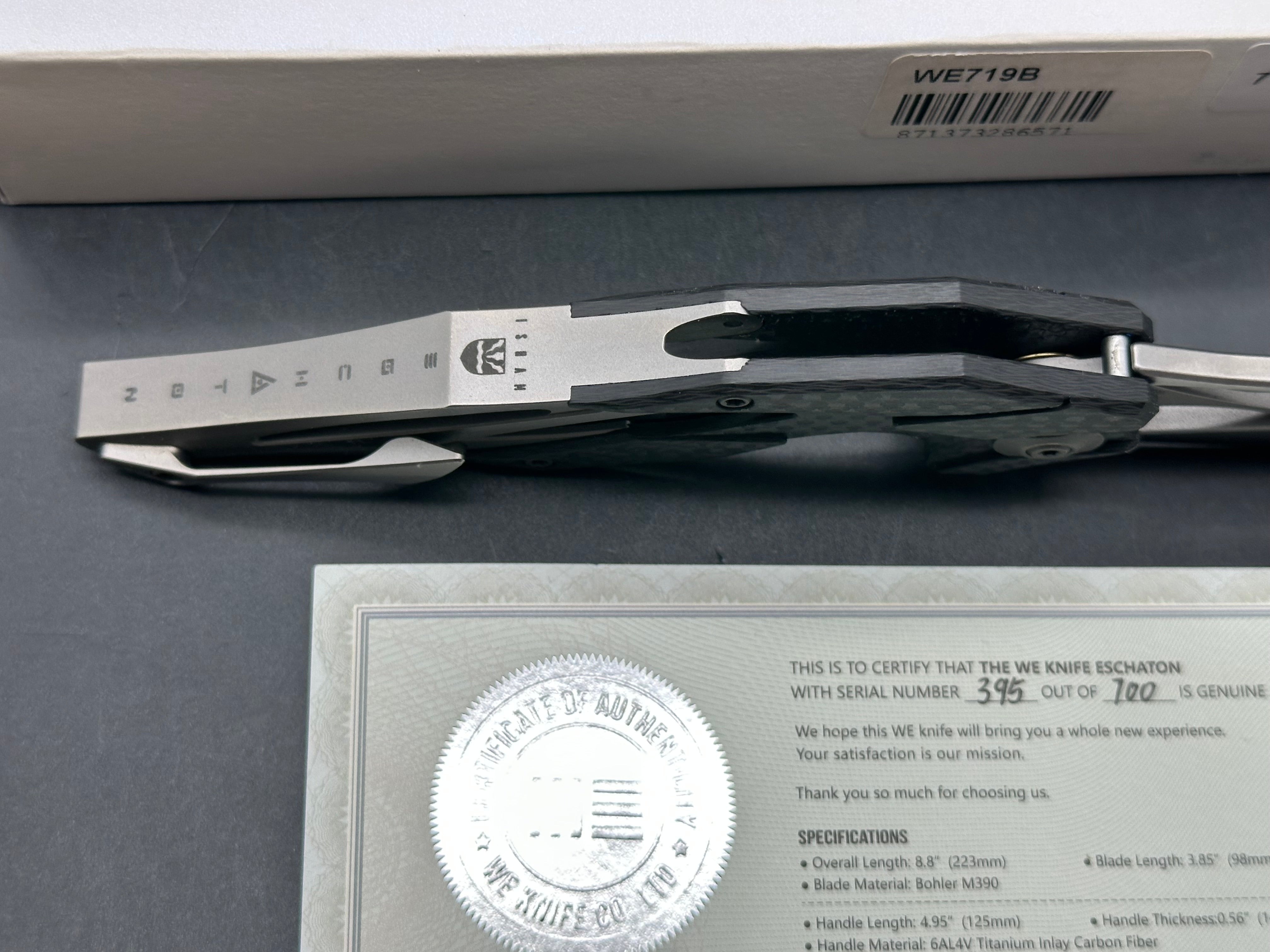 We Eschaton: Elijah Isham design. 3.83 inch, M390, flat grind wharncliffe blade Carbon fiber and titanium handle