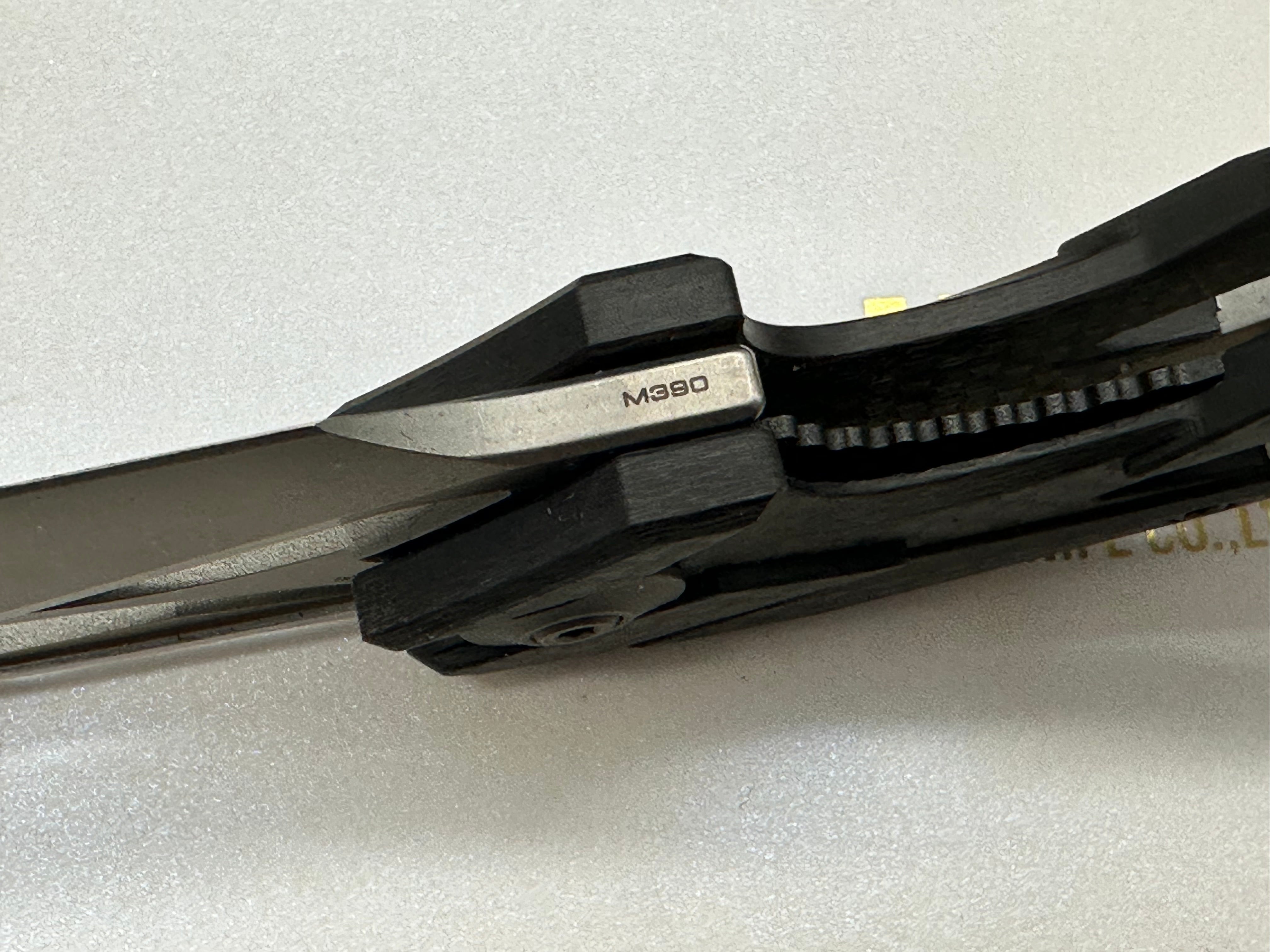 We Eschaton: Elijah Isham design. 3.83 inch, M390, flat grind wharncliffe blade Carbon fiber and titanium handle