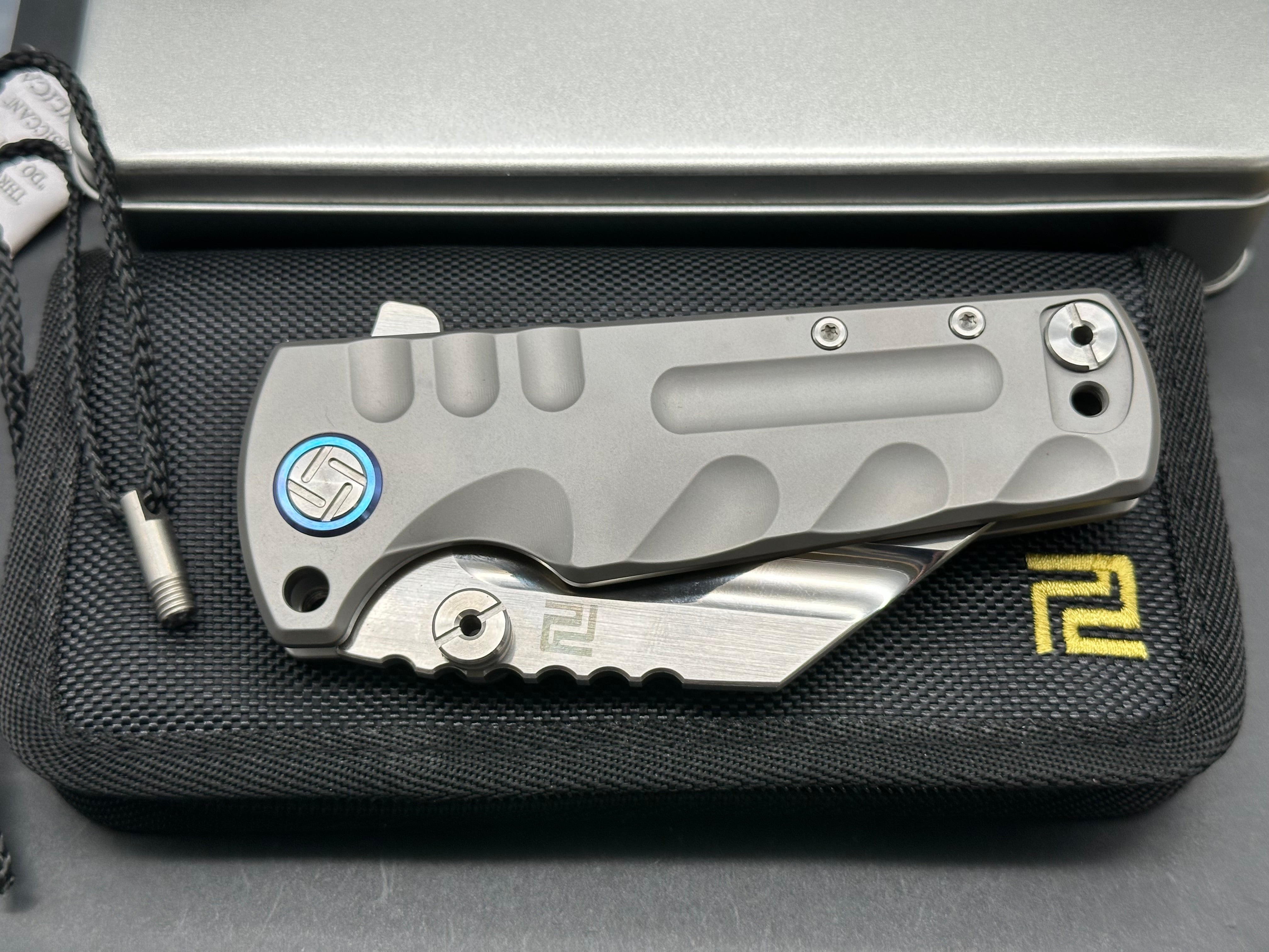 Artisan Cutlery Proponent: 3.85 inch, satin flat grind, s35VN Wharncliffe blade. Frame lock. Titanium handle