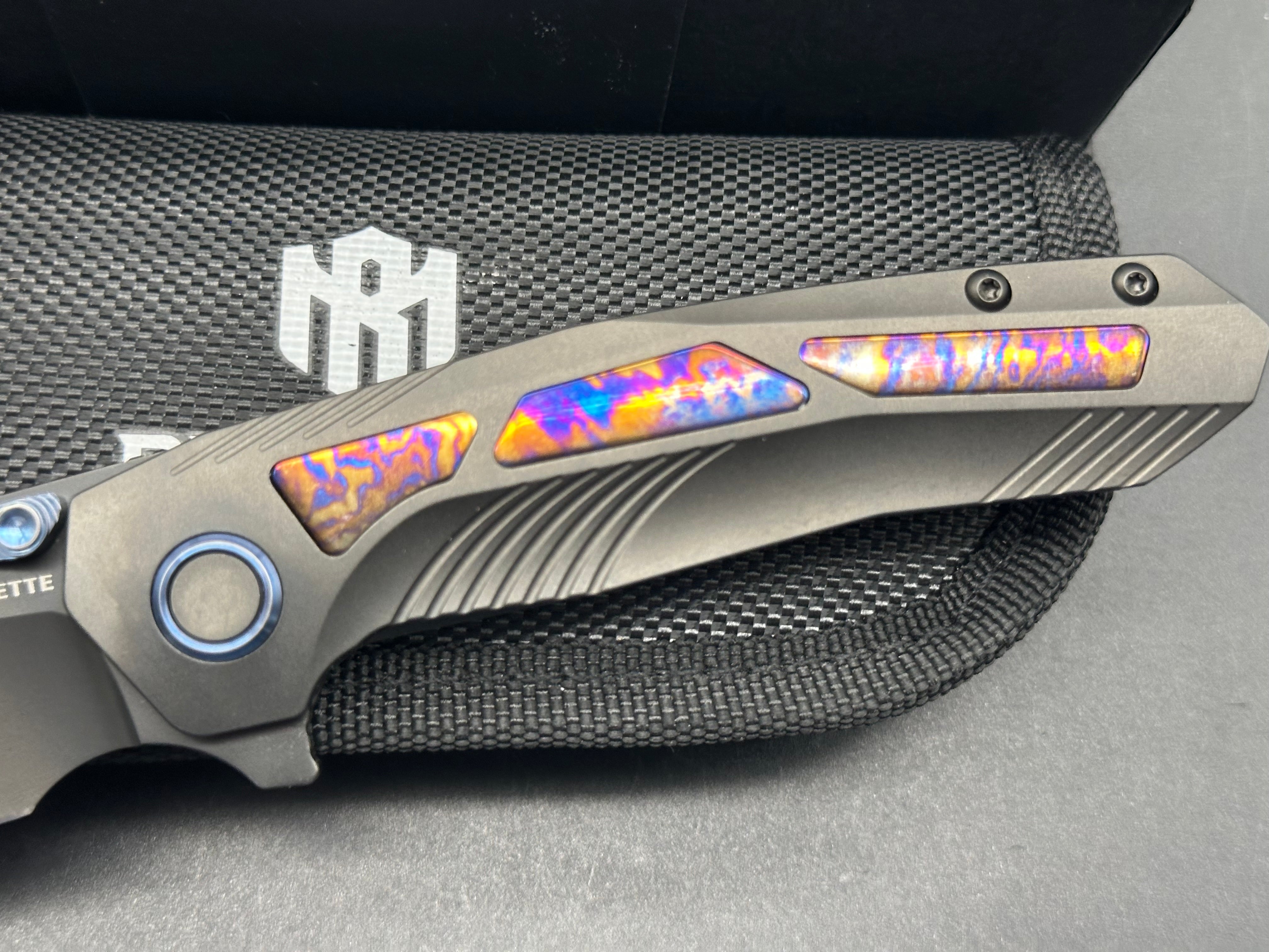 Remette RT-Kestrel with DLC titanium scales with Timascus inlay and clip. DLC S35vn blade
