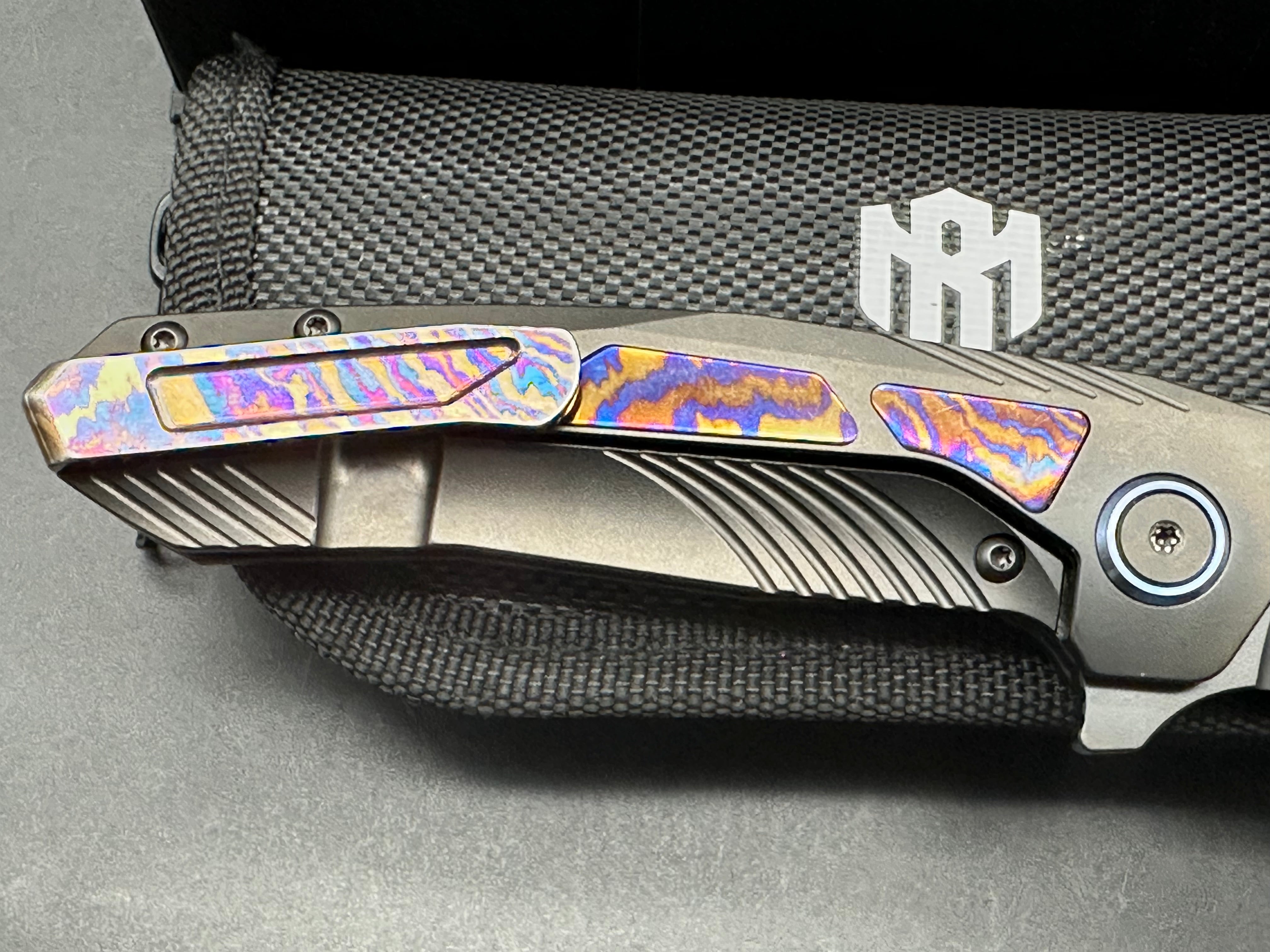 Remette RT-Kestrel with DLC titanium scales with Timascus inlay and clip. DLC S35vn blade