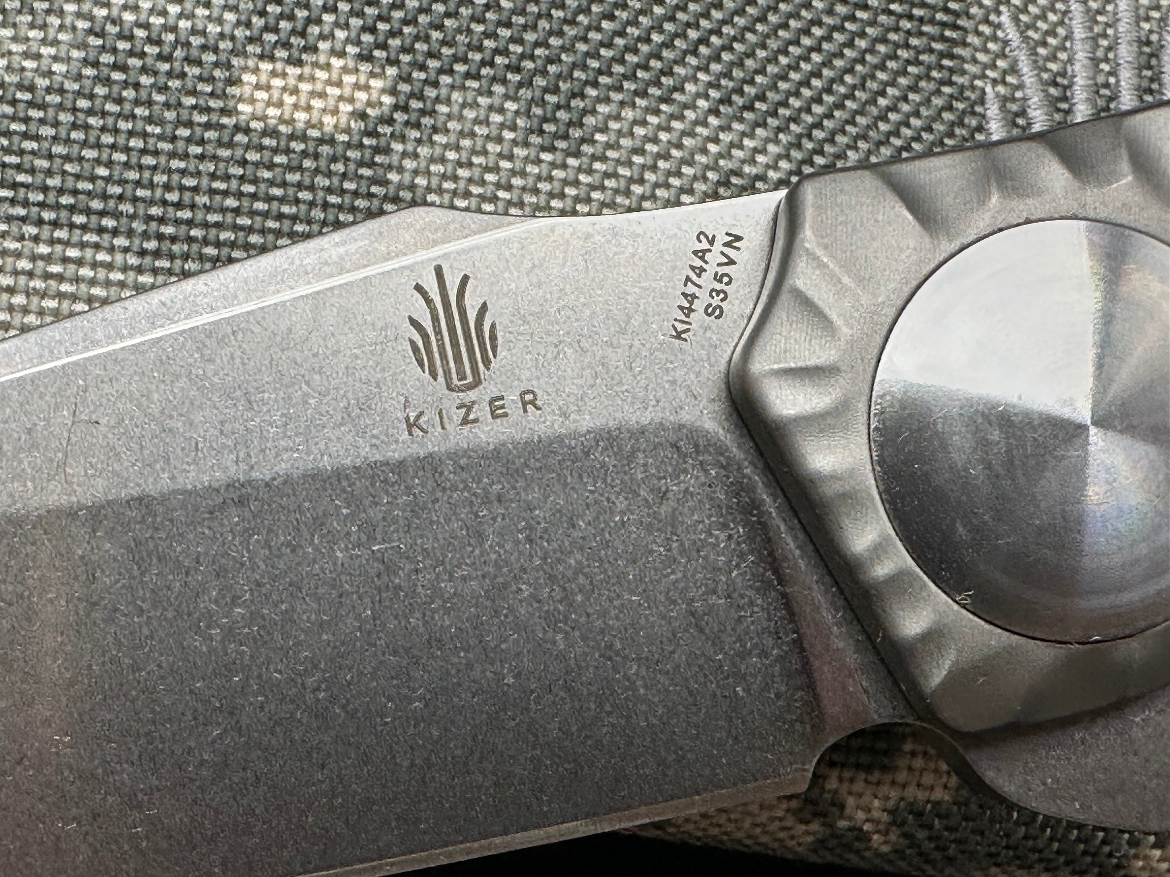 Kizer S.L.T.: John Gray design. 3.5 inch, hollow grind CPM-S35V blade. Frame lock. Titanium handle