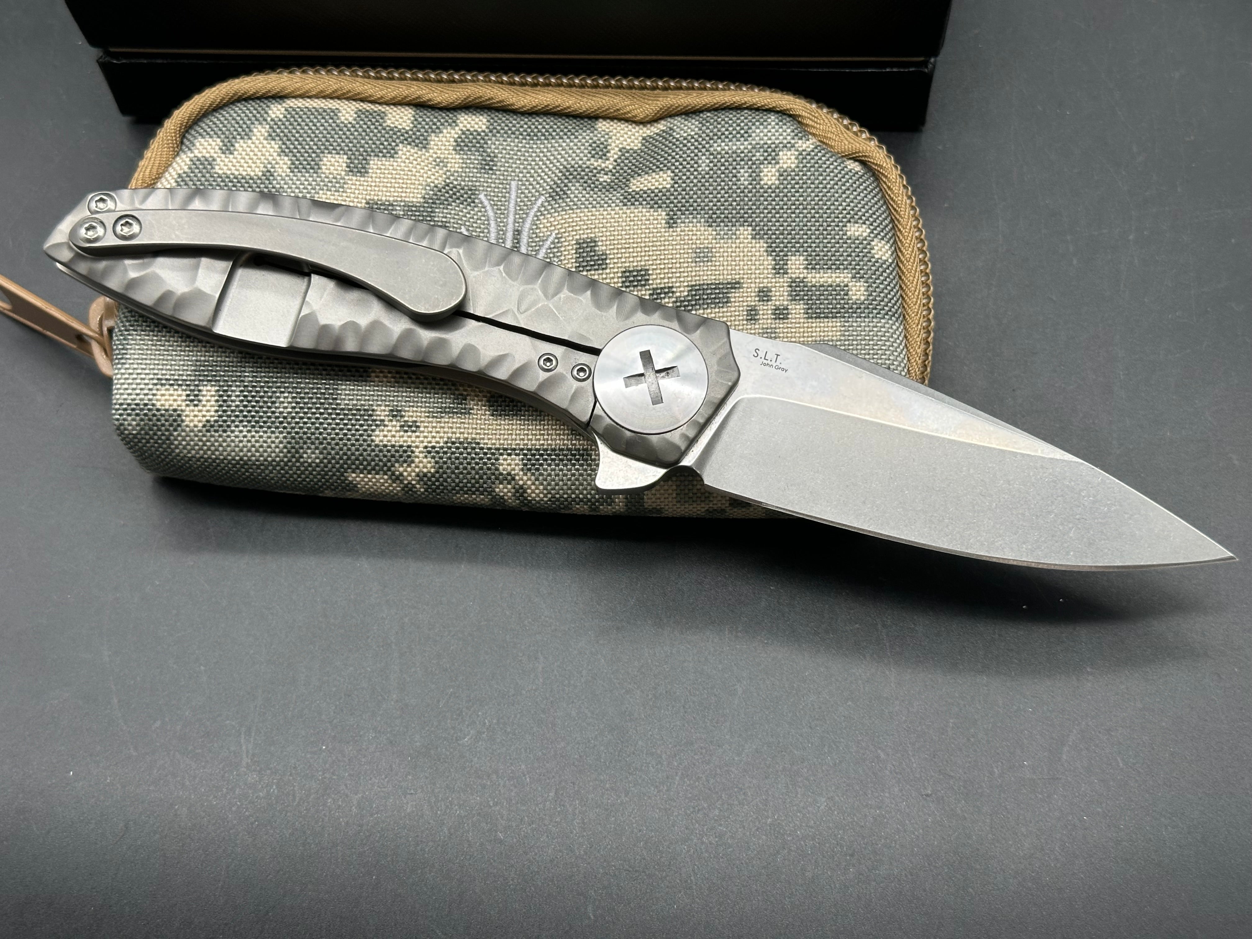 Kizer S.L.T.: John Gray design. 3.5 inch, hollow grind CPM-S35V blade. Frame lock. Titanium handle