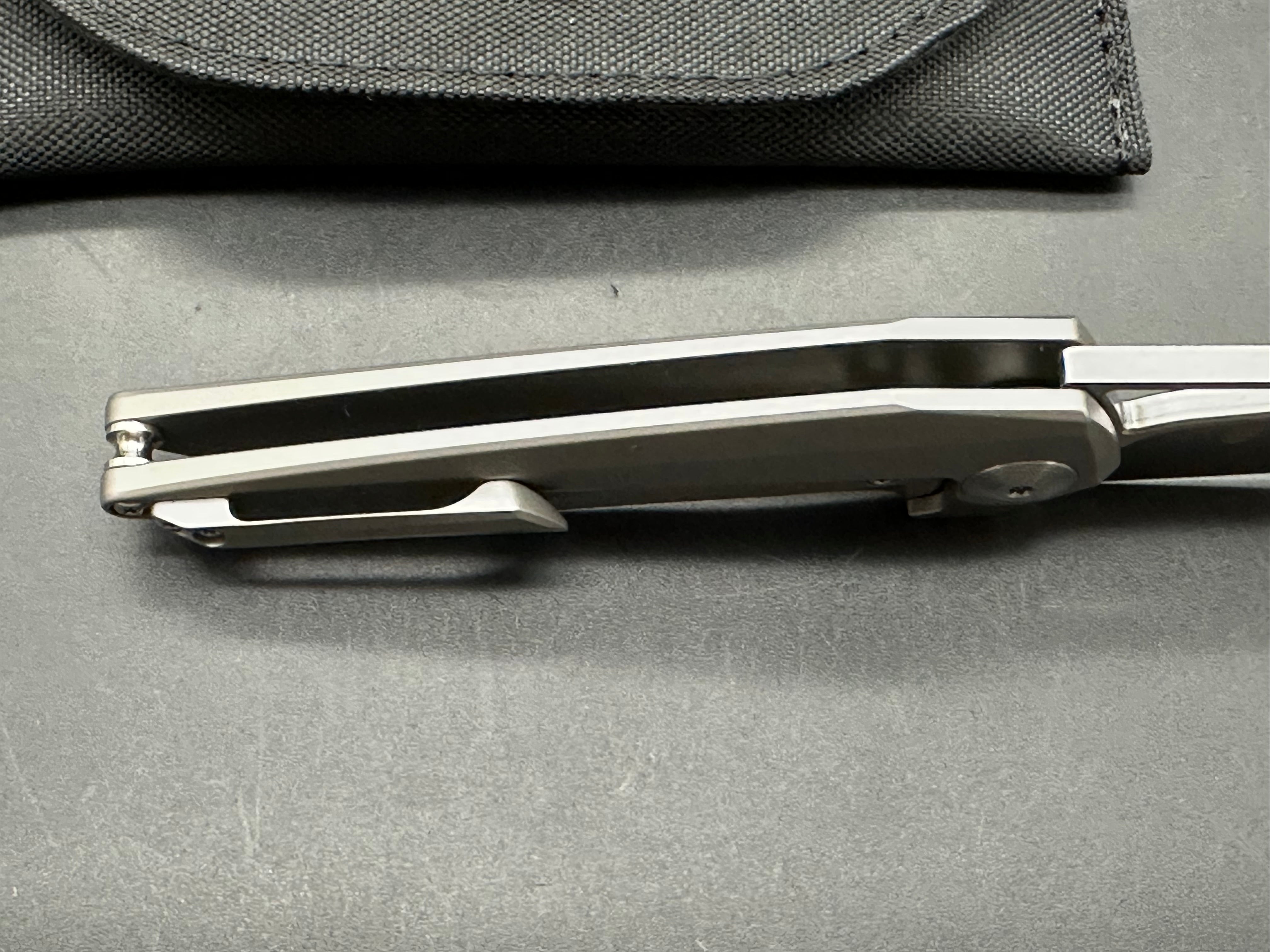 Kizer Theta: Elijah Isham design. 3.125 inch, stonewashed, flat grind, Wharncliffe CMP-S35V blade. Titanium handle