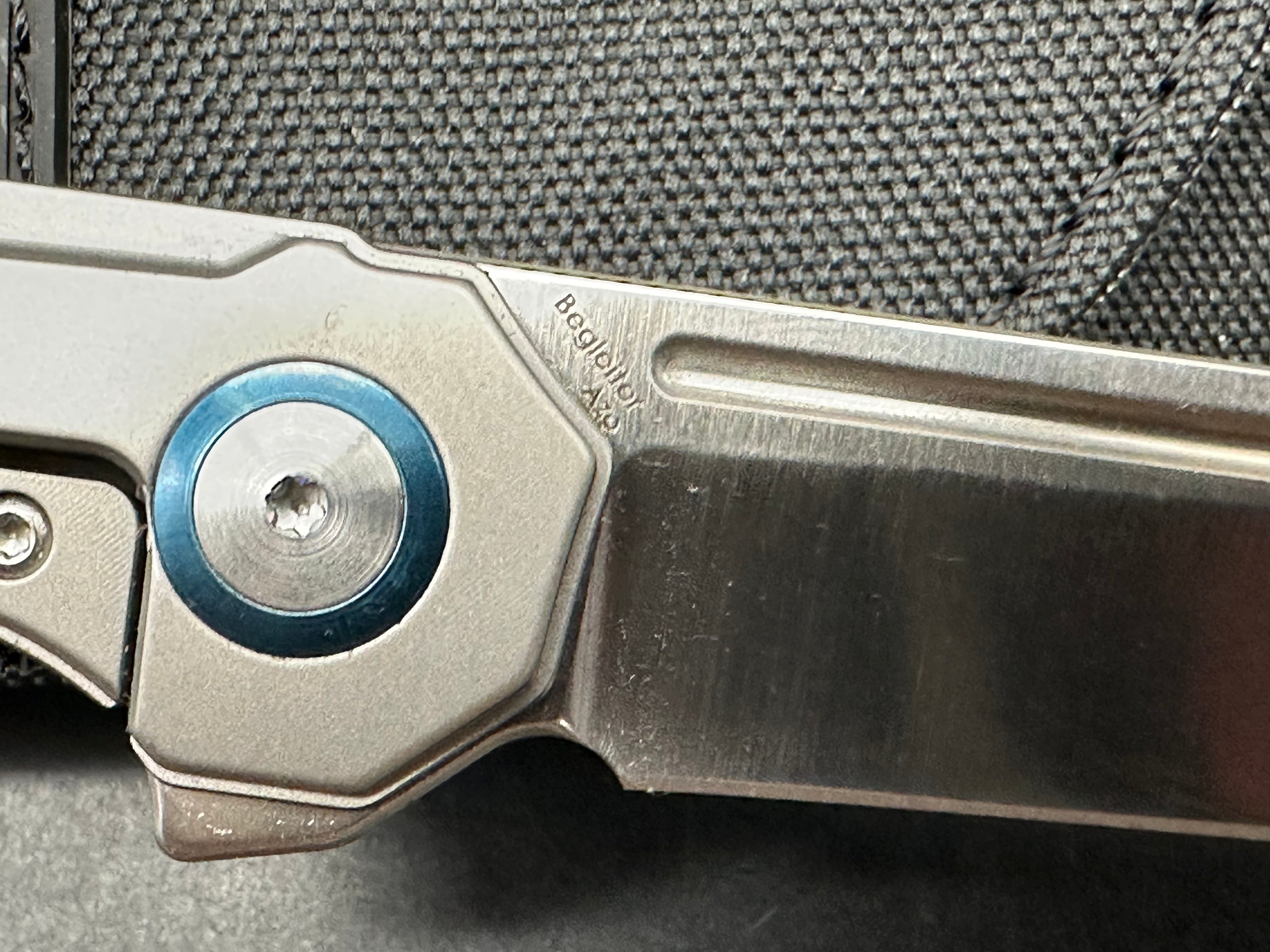 Kizer Begleiter: Azo design. 3.5 inch hollow grind CPM-S35V tanto blade. Titanium handle with anodized blue pivot