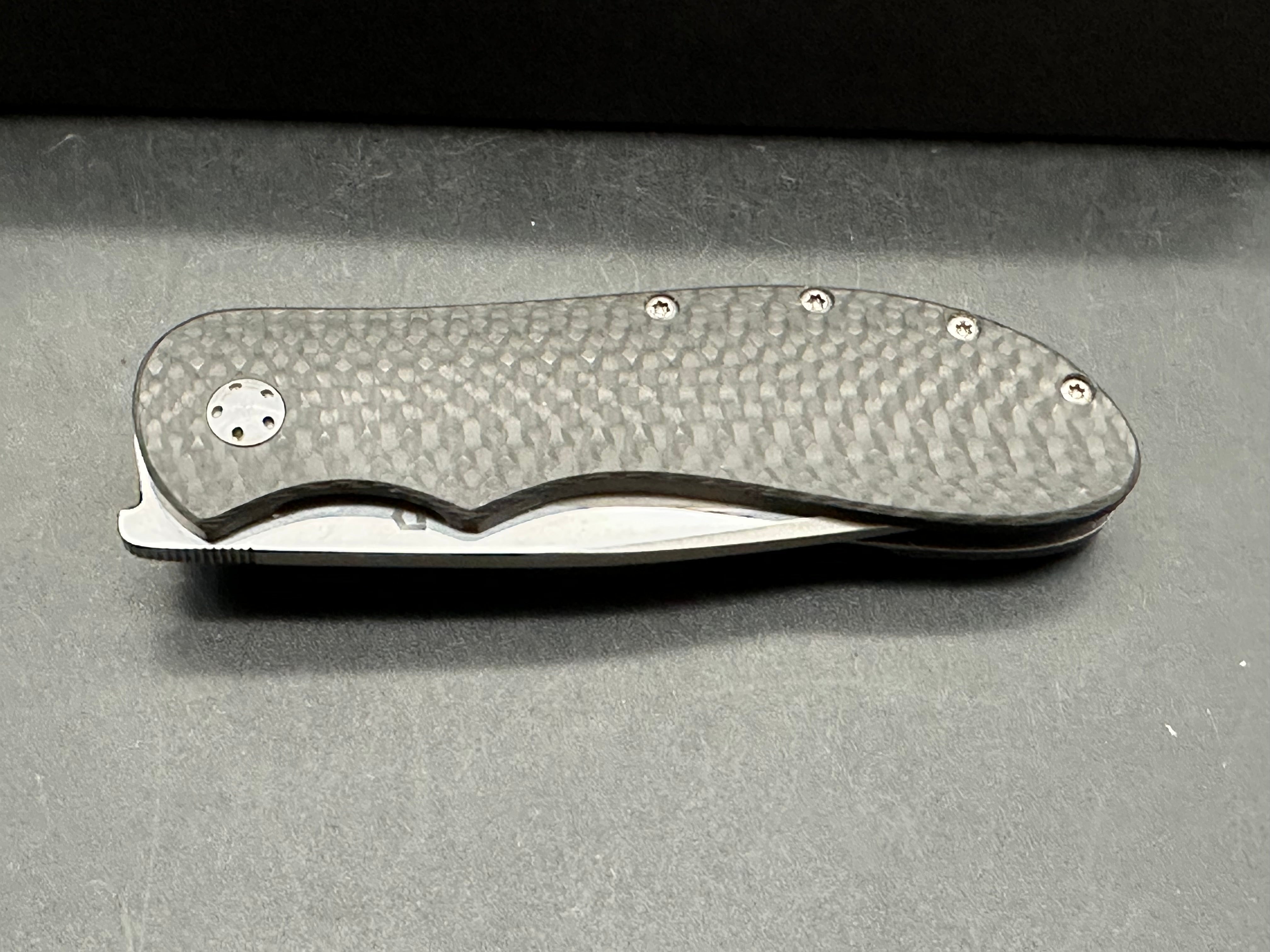 JD Van Deventer EDC Front Flipper 2.75 inch drop point, stone washed two tone N690 blade. Acid tumble titanium frame with carbon fiber handle
