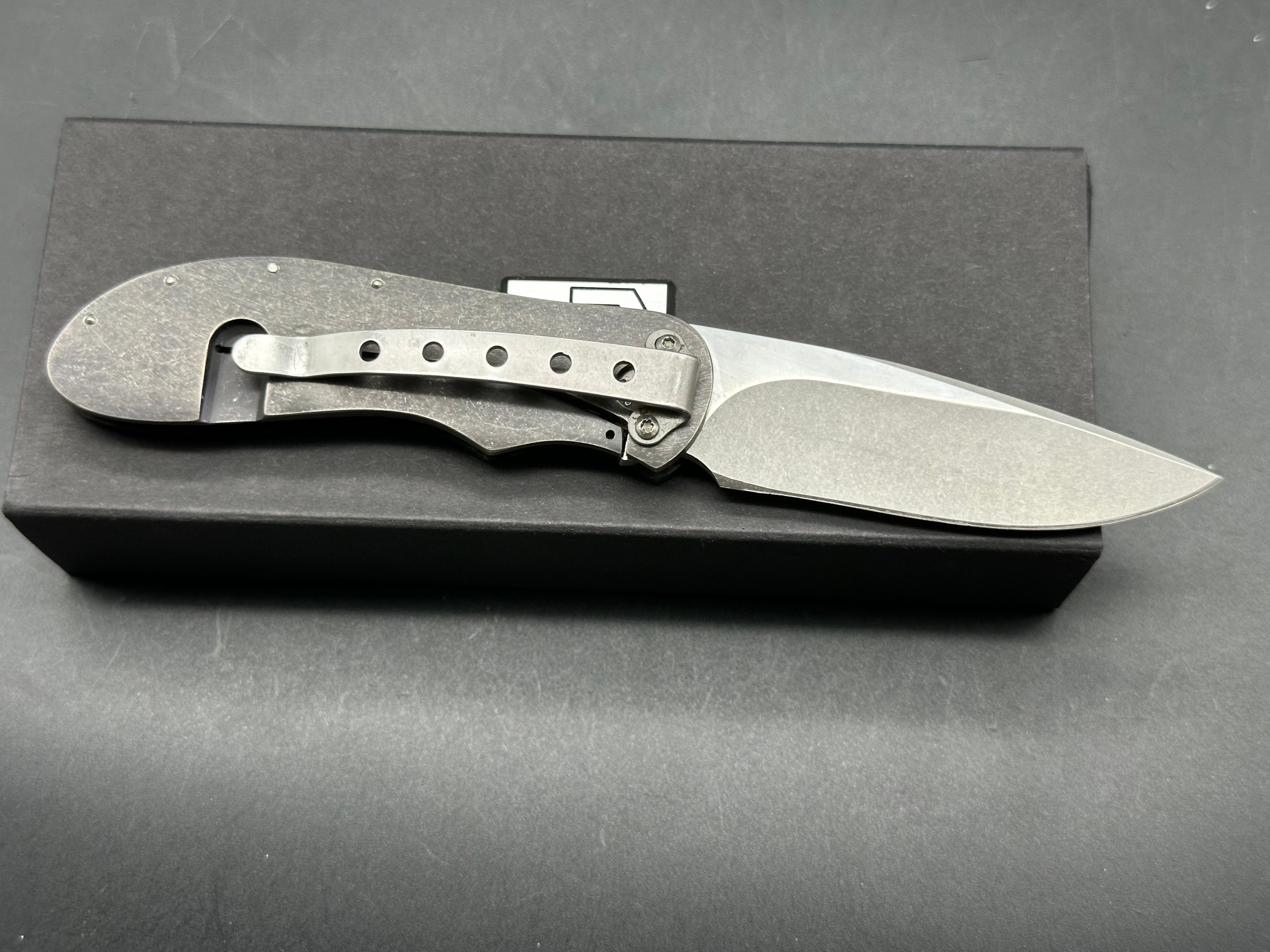 JD Van Deventer EDC Front Flipper 2.75 inch drop point, stone washed two tone N690 blade. Acid tumble titanium frame with carbon fiber handle