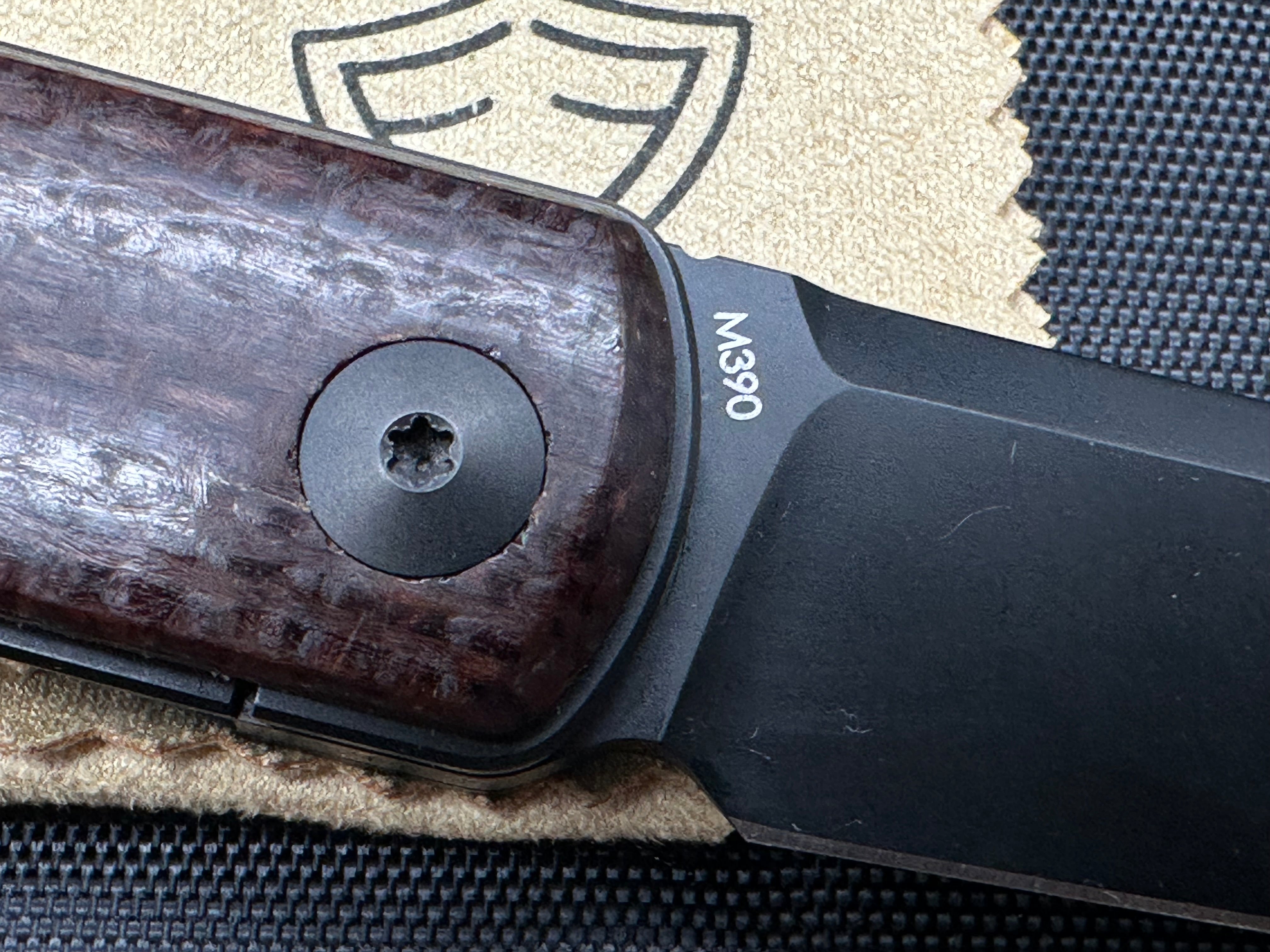 Reate Bushido: 3 inch trailing point, flat grind, blackwash, M390 blade. Front flipper. Blackwash titanium clip. Brown micarta handle