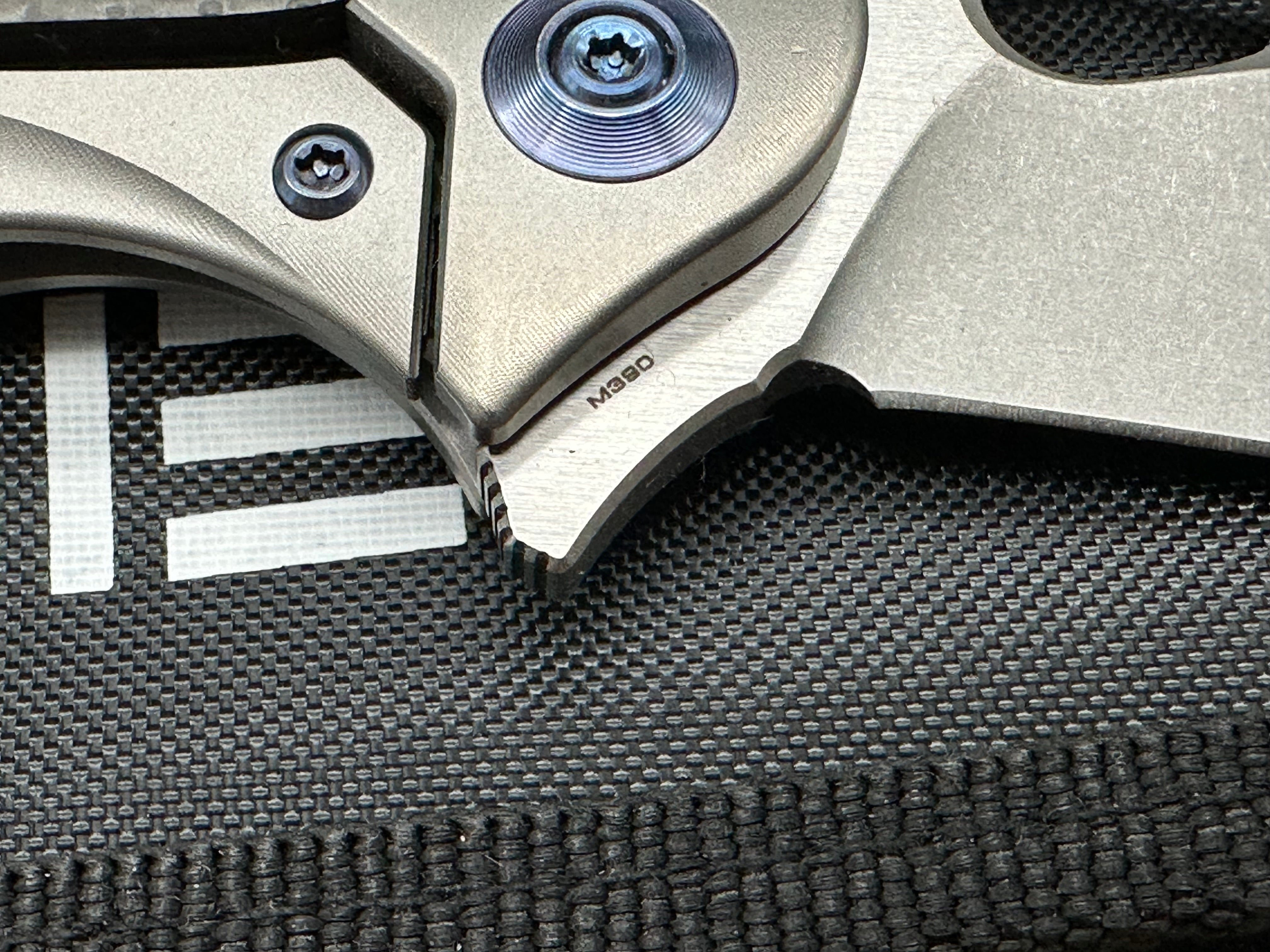 We Knives Zephyr: 3.5 inch drop point, flat grind, Bohler M390 blade. Titanium handle with carbon fiber inset
