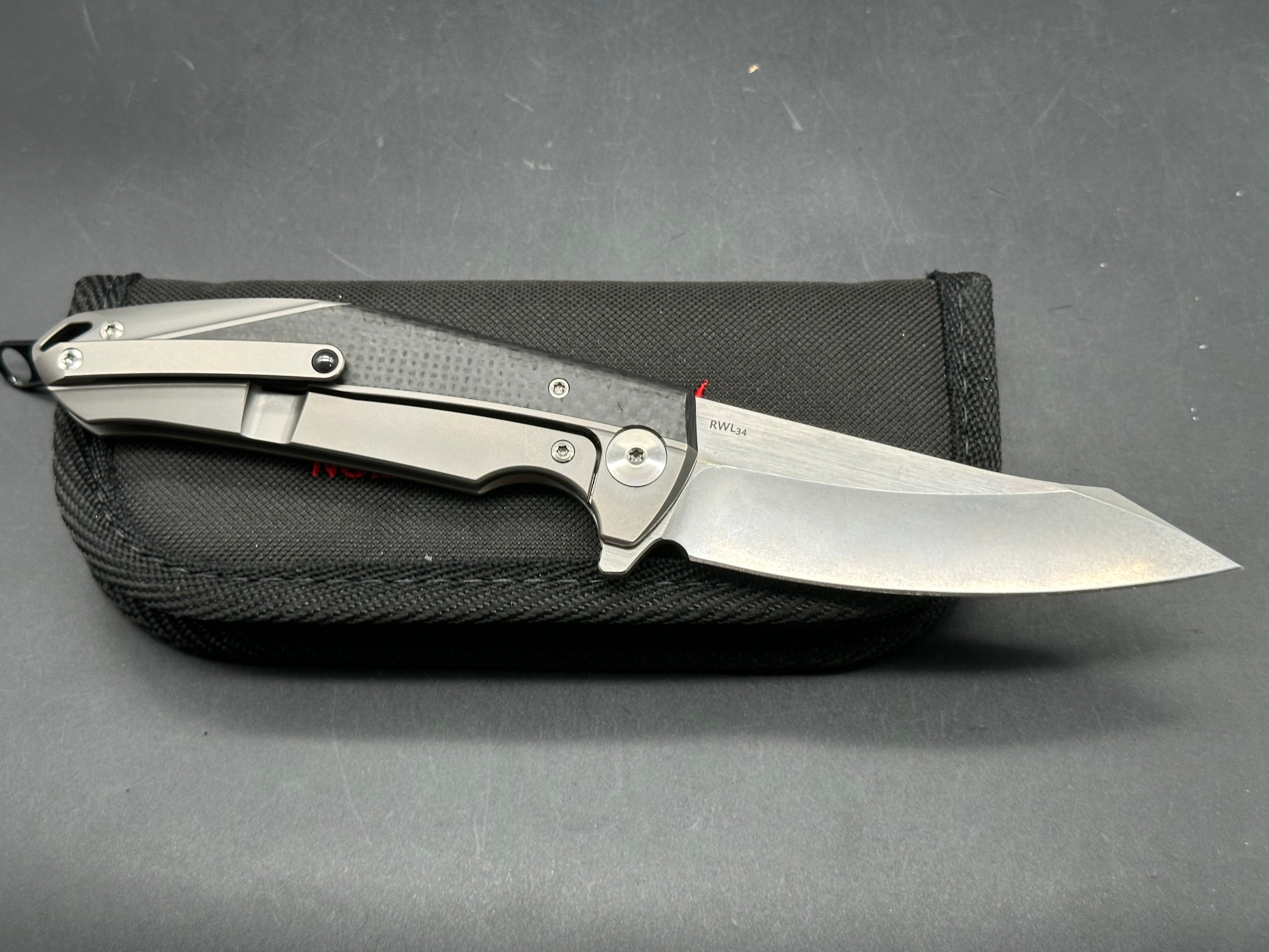 Reate K1: 3.875 inch RWL-34 blade. Steel overtravel stop. Titanium and carbon fiber handle