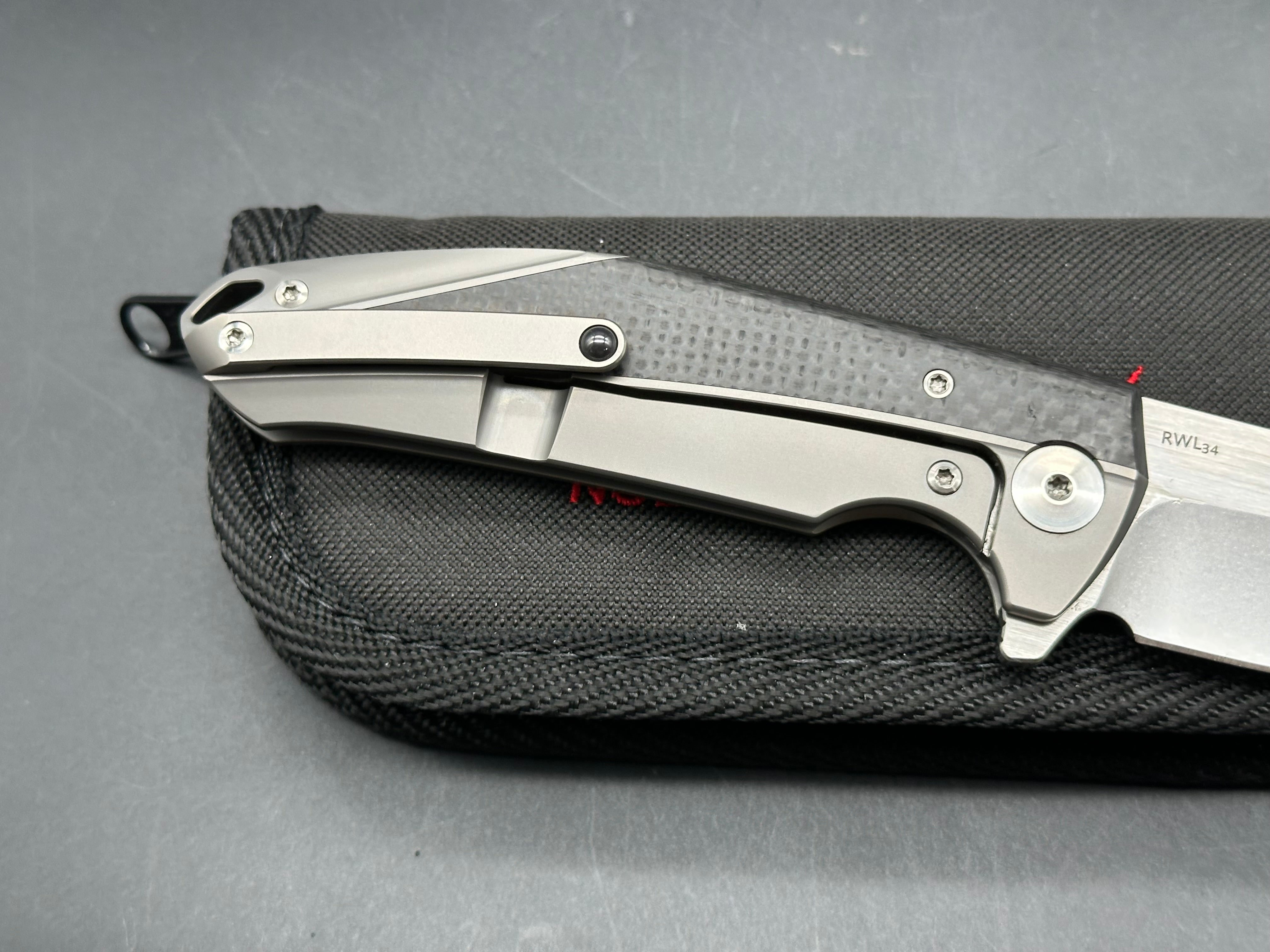 Reate K1: 3.875 inch RWL-34 blade. Steel overtravel stop. Titanium and carbon fiber handle
