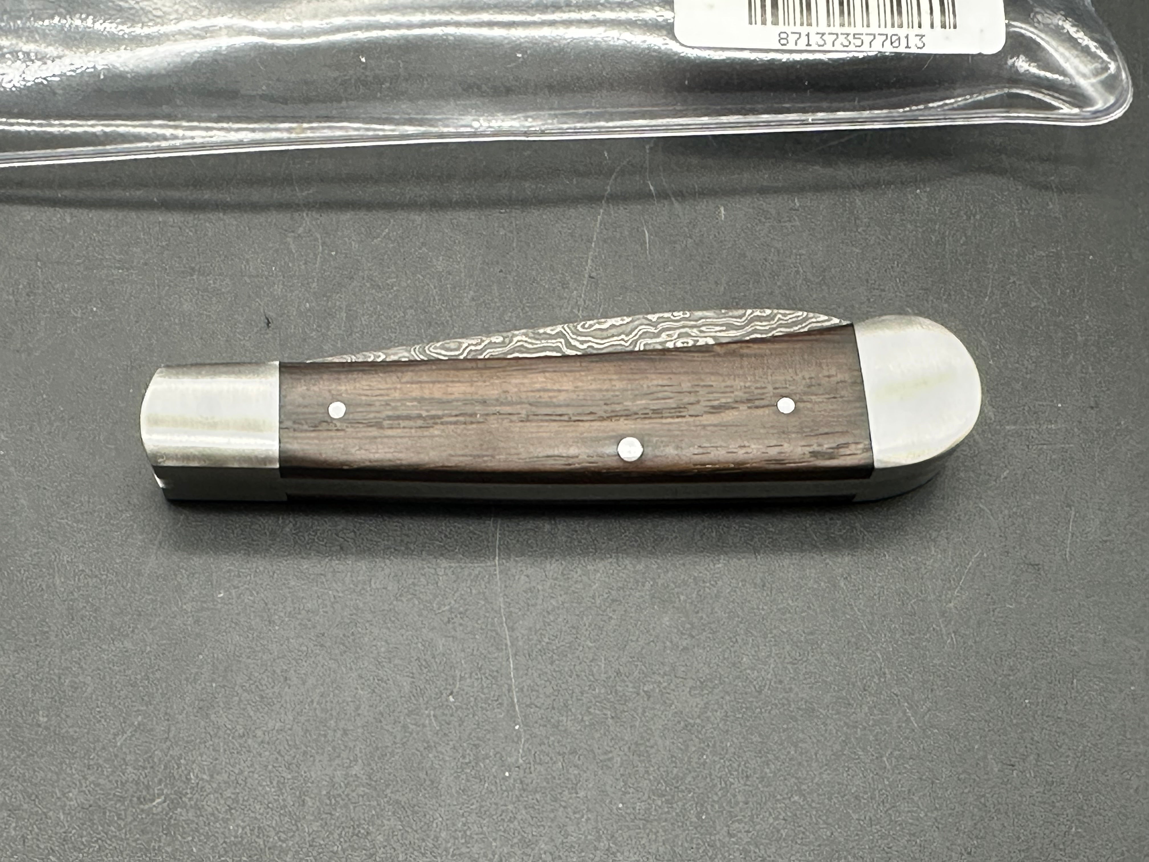 Otter Messer slipjoint with Damascus. Oak covers. 2.95 inch blade