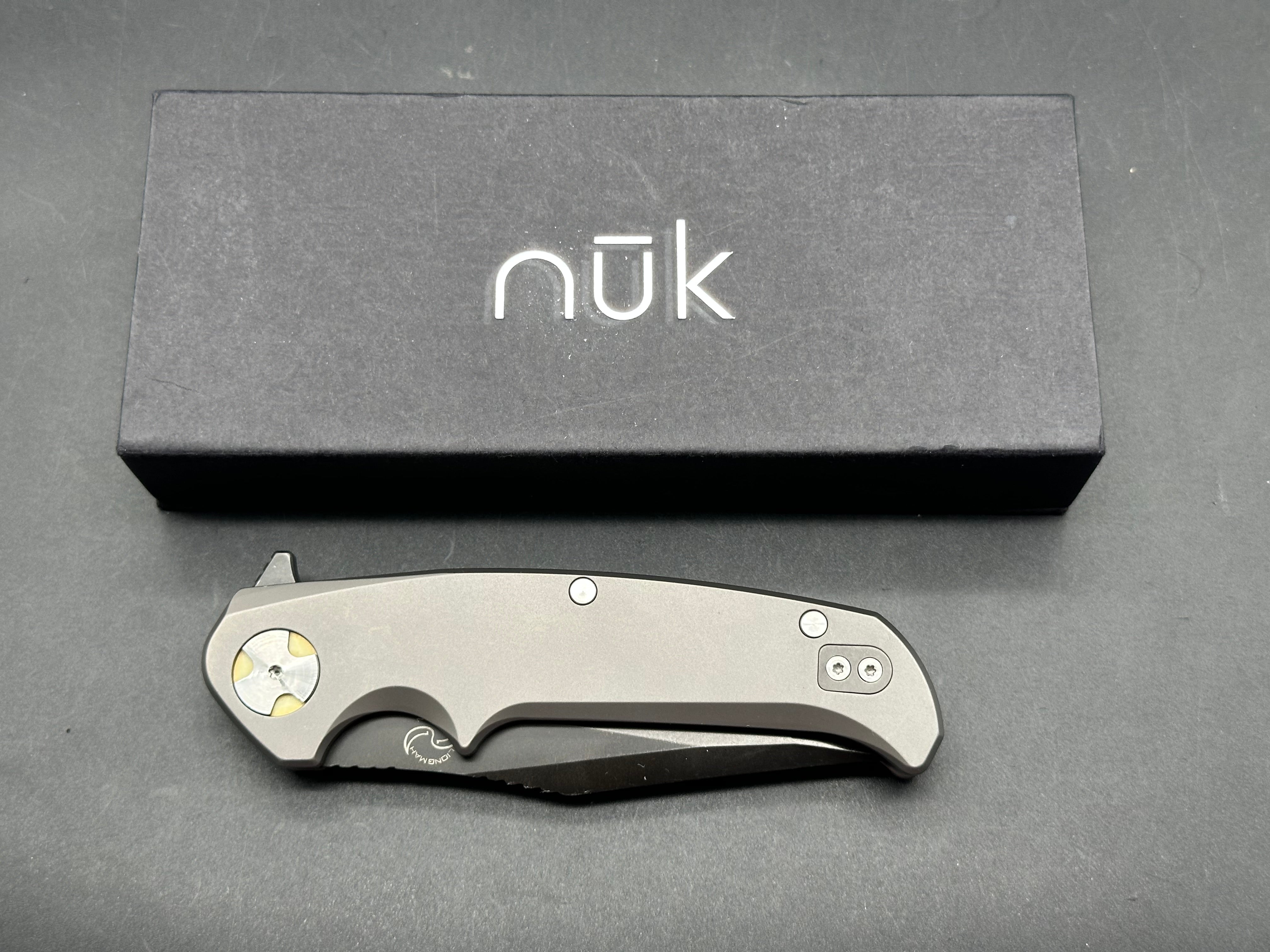 NUK from Liong Mah Designs stainless steel handles, moonglow inserts in the pivot and liners and D2 blade