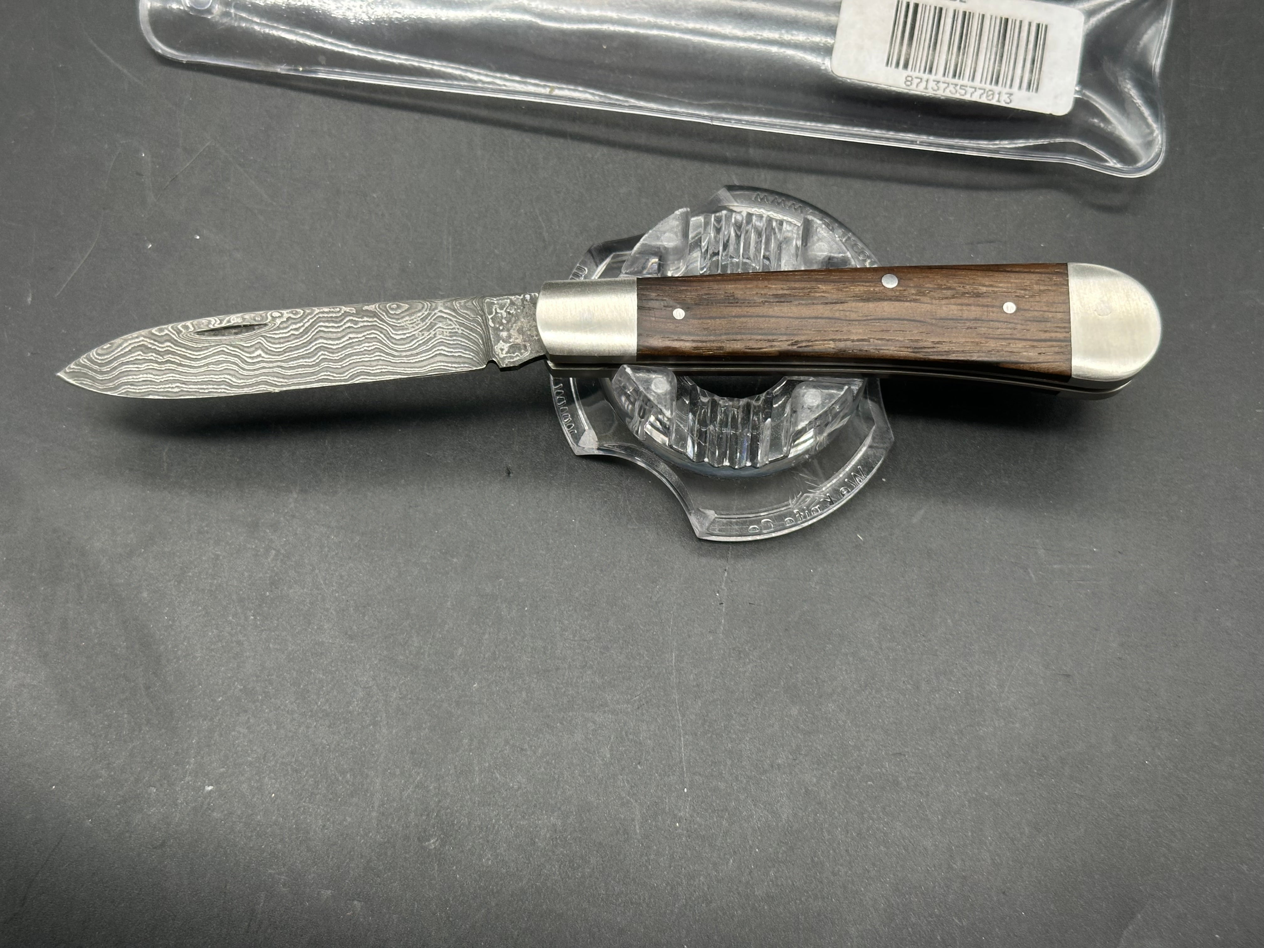 Otter Messer slipjoint with Damascus. Oak covers. 2.95 inch blade