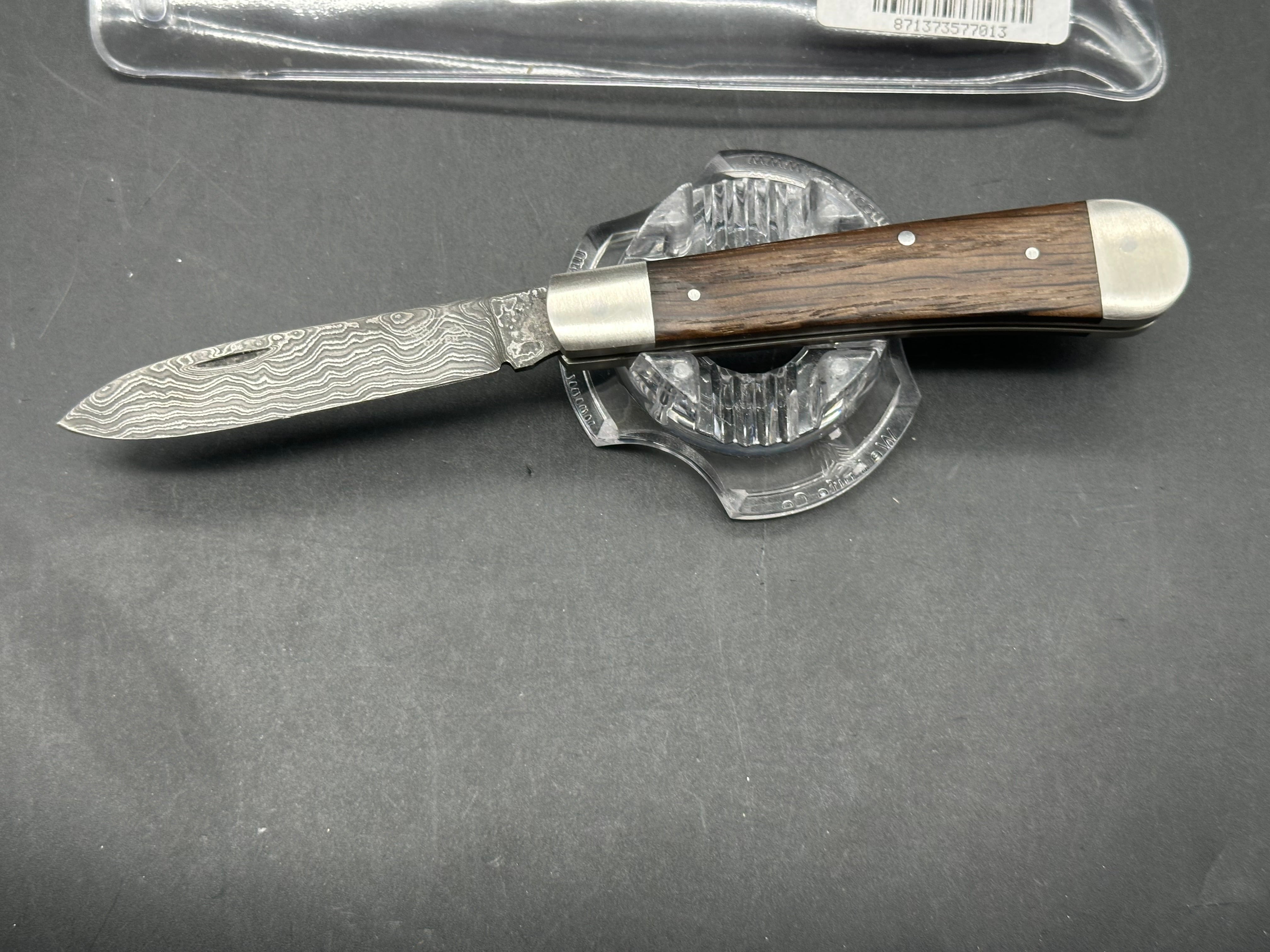 Otter Messer slipjoint with Damascus. Oak covers. 2.95 inch blade