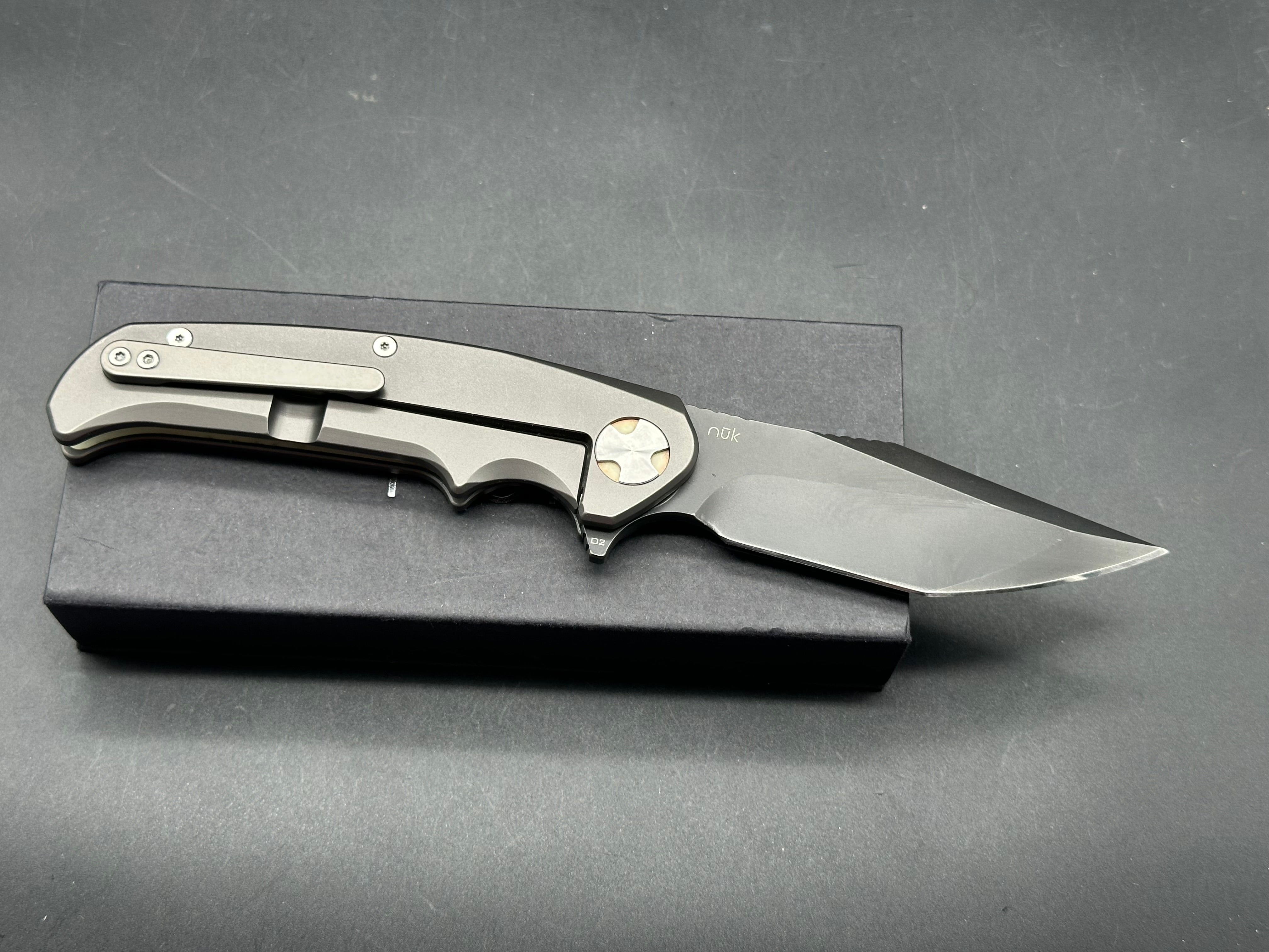 NUK from Liong Mah Designs stainless steel handles, moonglow inserts in the pivot and liners and D2 blade