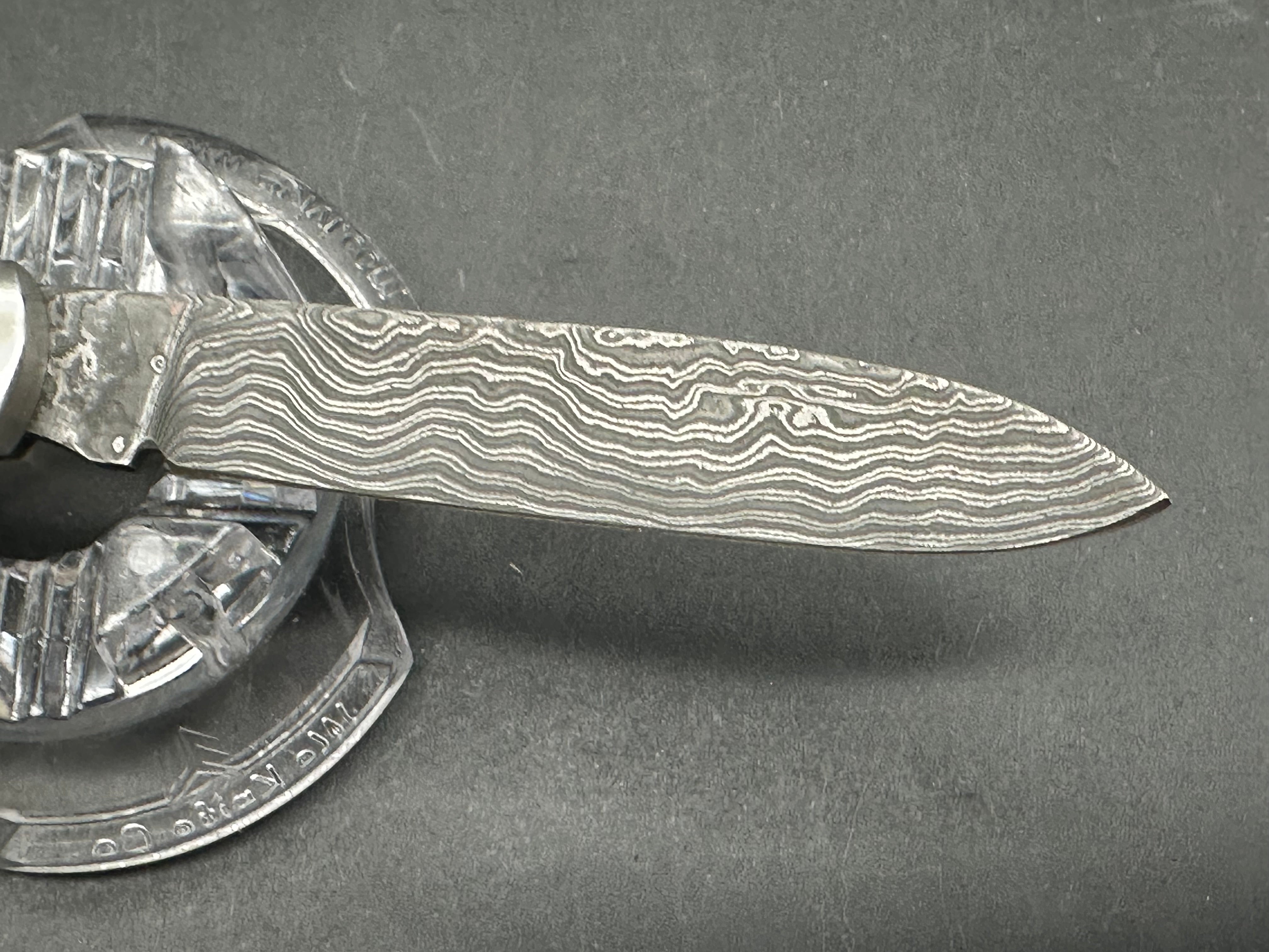 Otter Messer slipjoint with Damascus. Oak covers. 2.95 inch blade