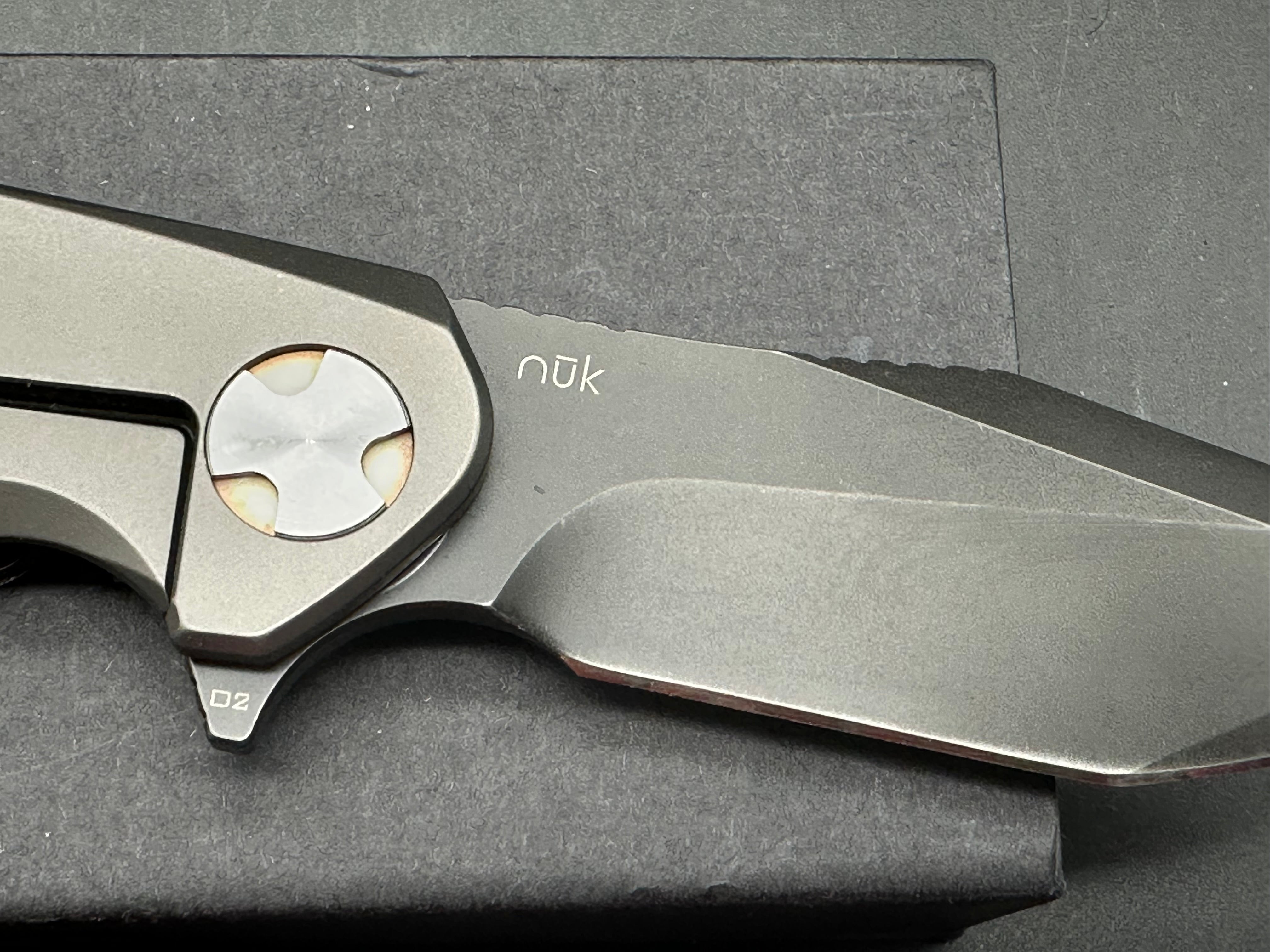 NUK from Liong Mah Designs stainless steel handles, moonglow inserts in the pivot and liners and D2 blade
