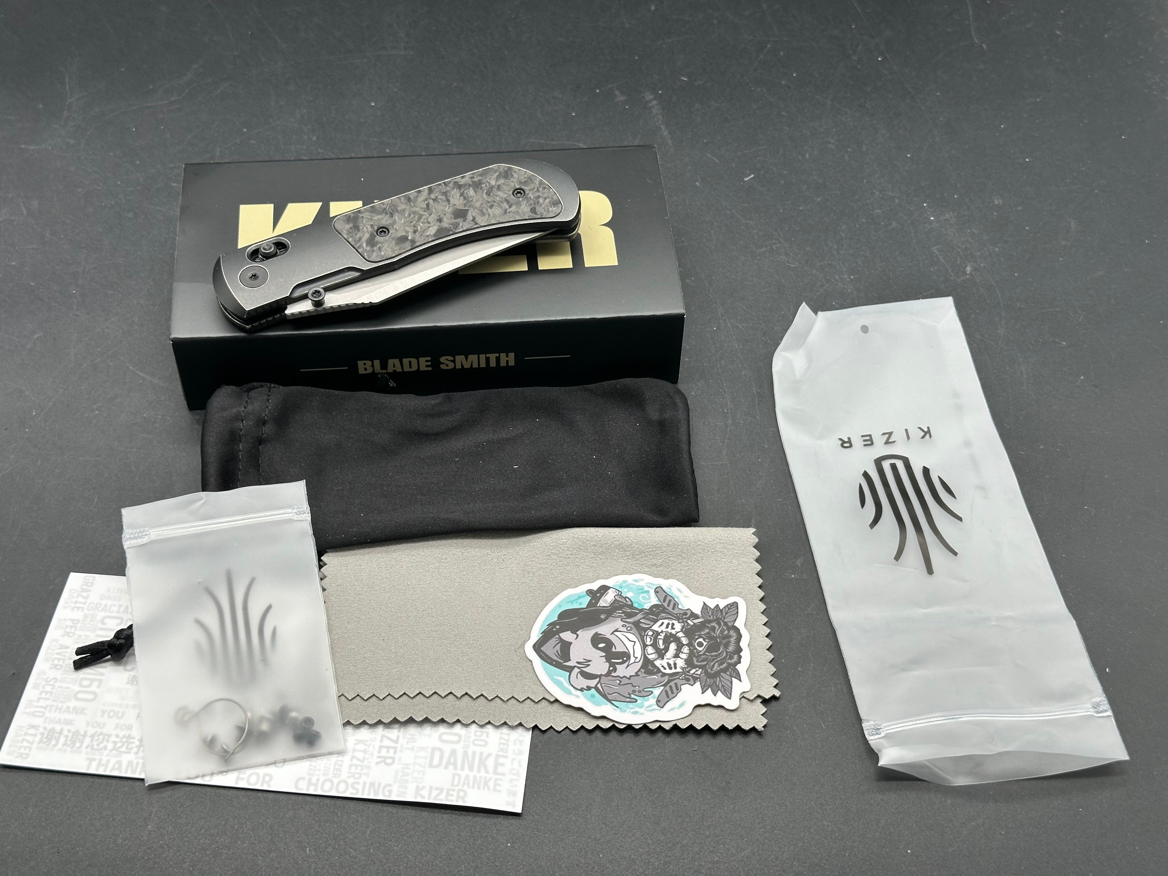 KIZER TYCHO FOLDING KNIFE TITANIUM/CARBON FIBER HANDLE M390 CLIP POINT PLAIN EDGE STONEWASH FINISH