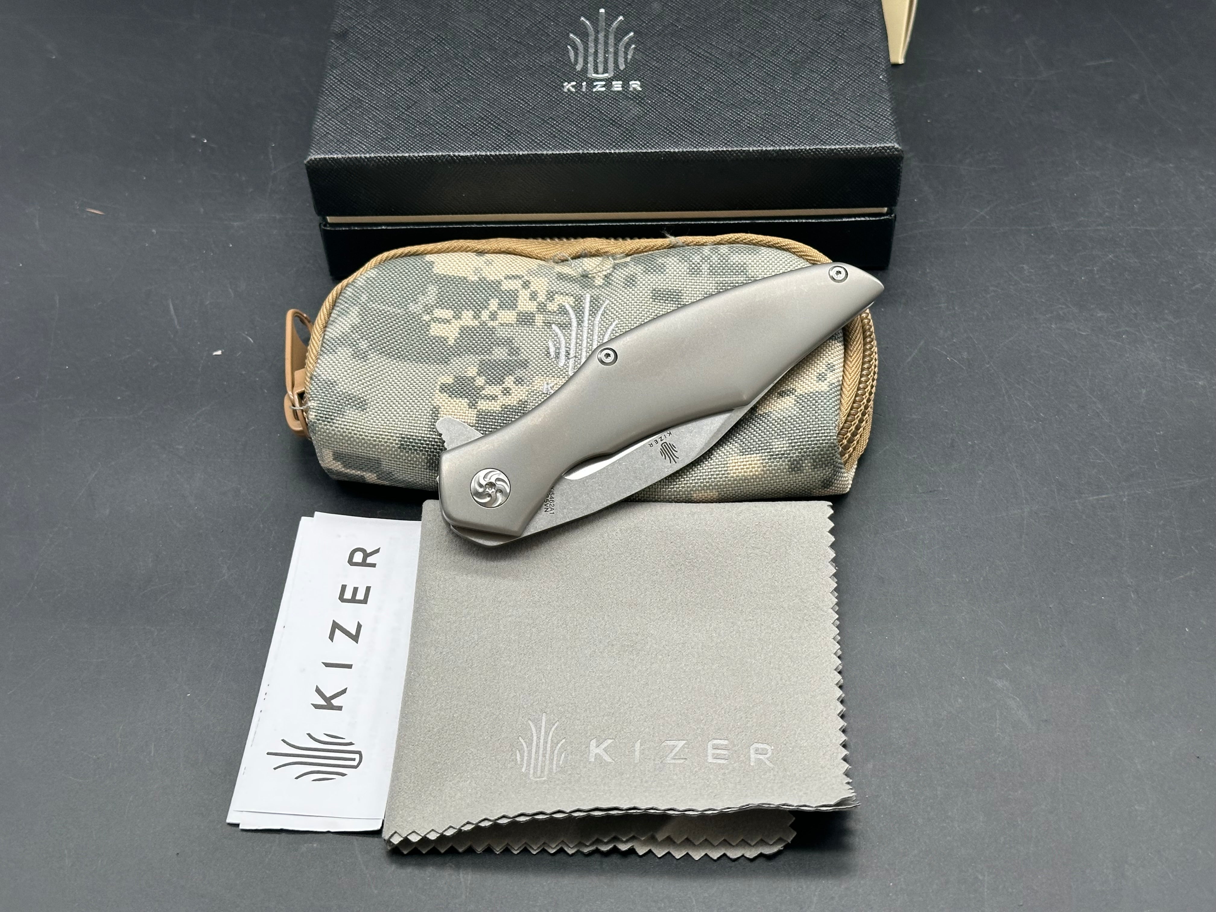 Kizer Trifecta: Matt Cuchiara design. 3.875 stonewash, drop point, hollow grind CPM-S35VN blade. Titanium handle with milled titanium clip