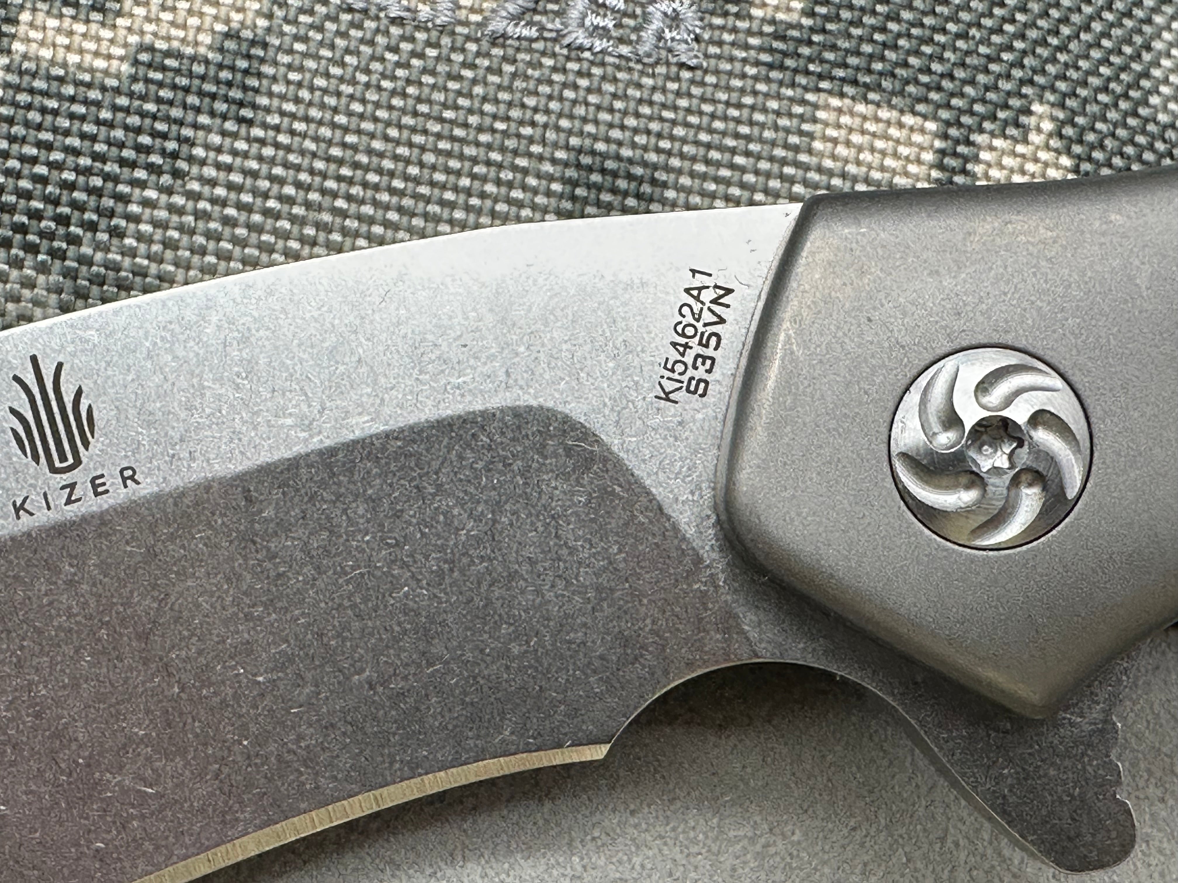 Kizer Trifecta: Matt Cuchiara design. 3.875 stonewash, drop point, hollow grind CPM-S35VN blade. Titanium handle with milled titanium clip
