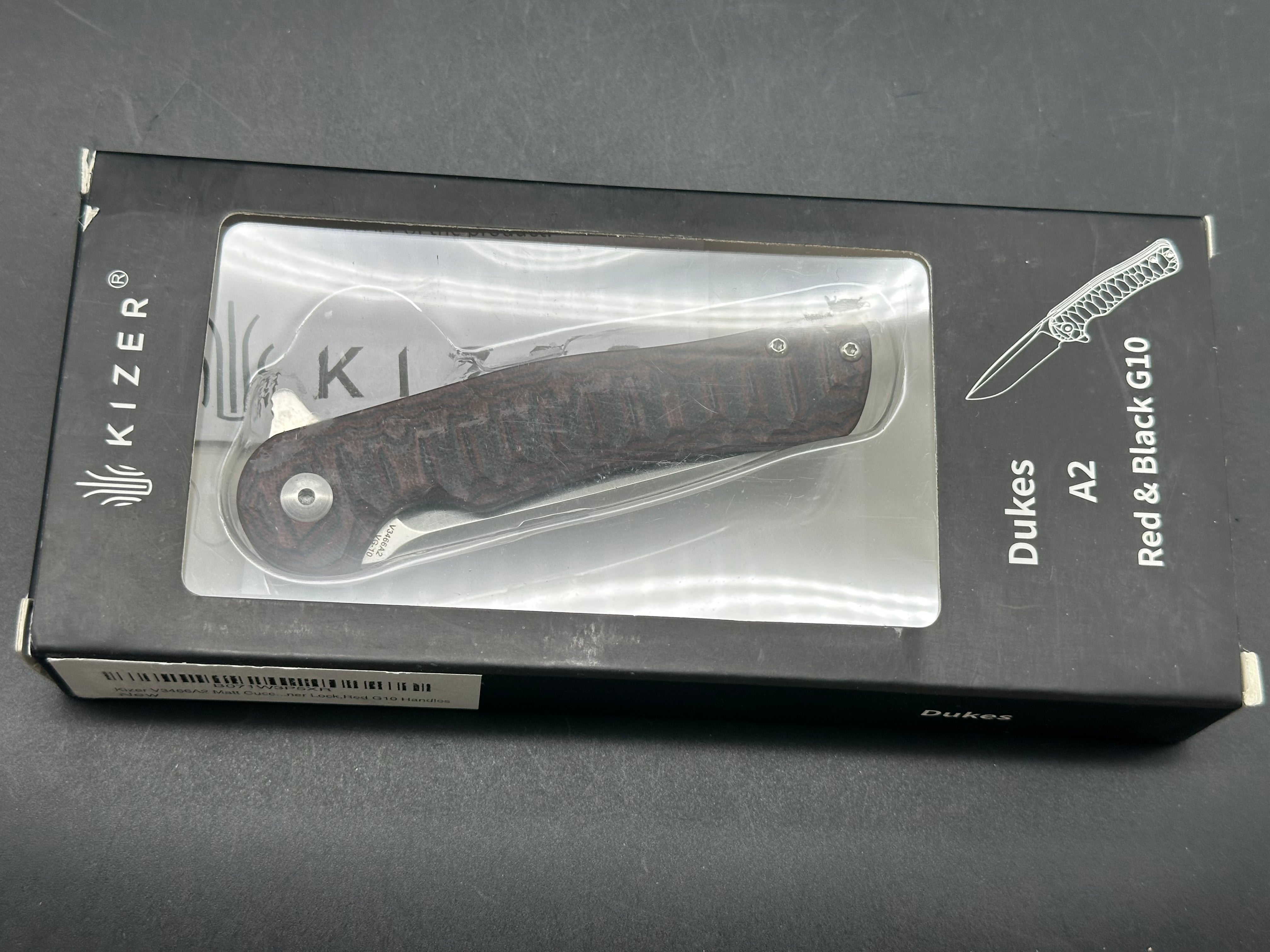 Kizer Dukes A2: Matt Cucchiara design. 3 inch drop point, hollow grind VG-10 blade. Red G-10 handle