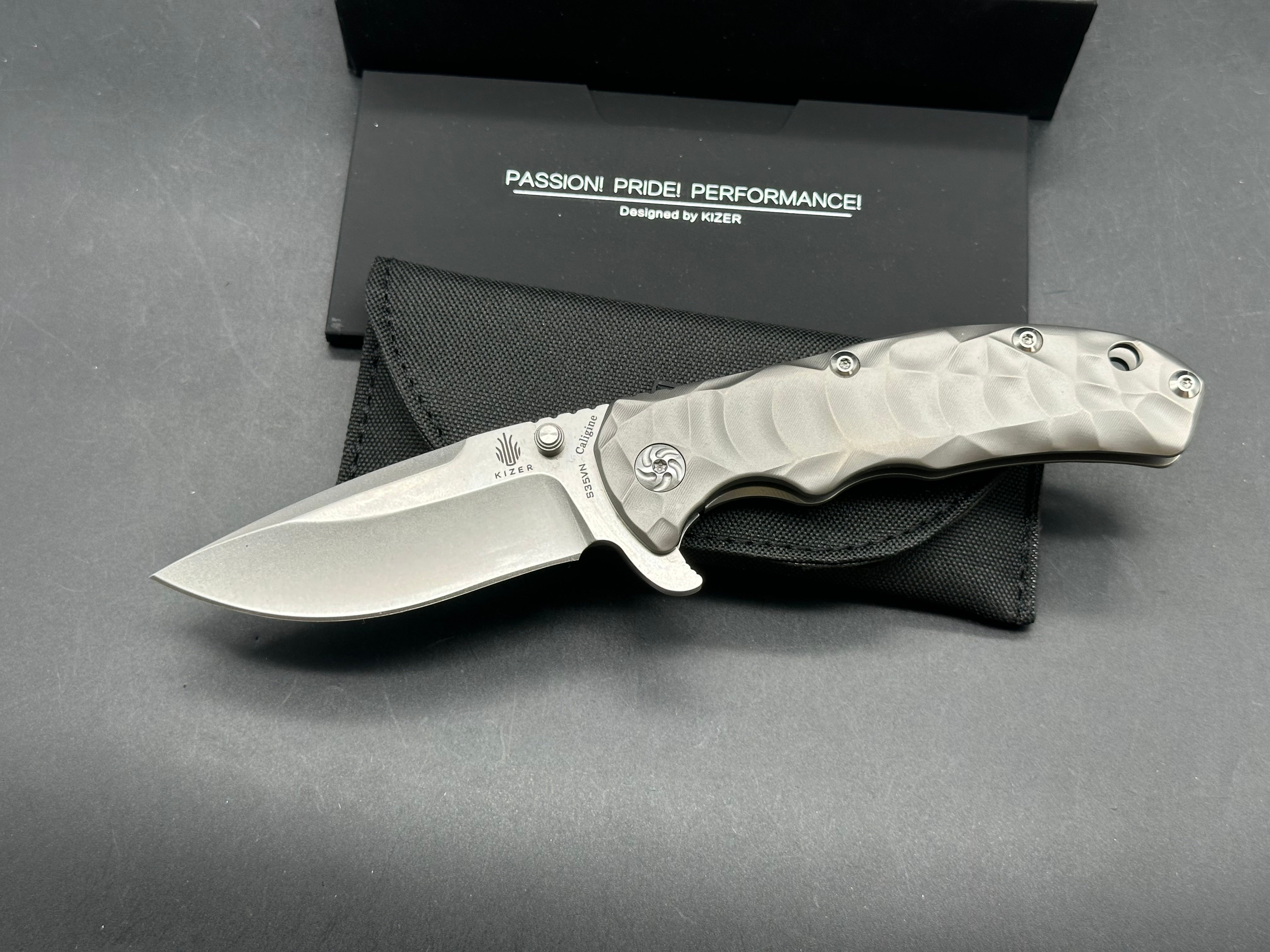 Kizer Caligine 3.58 inch stonewash, drop point, flat grind CPM-S35VN blade. Frame lock. Titanium handle. Titanium clip