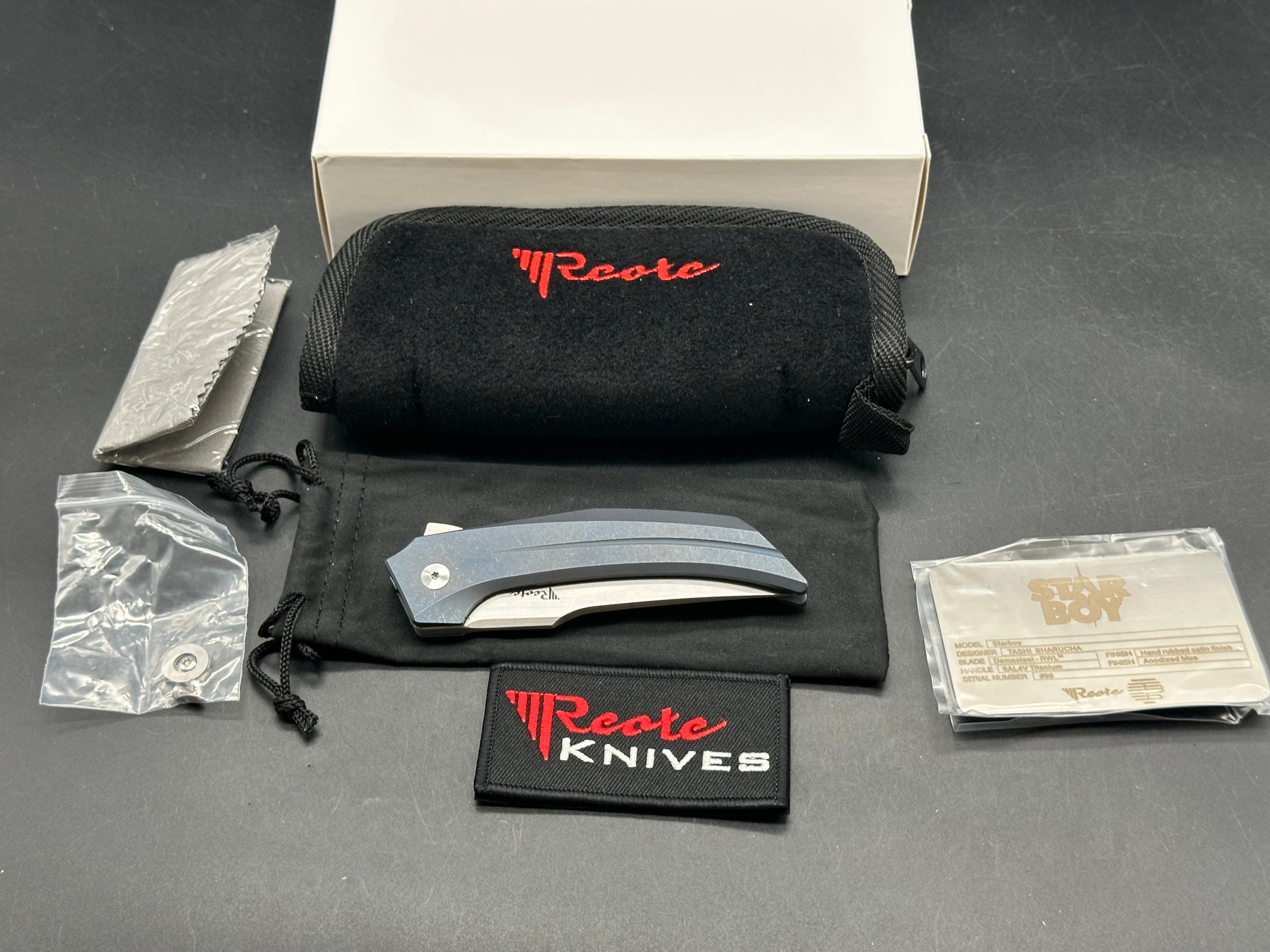 Reate Starboy: Tashi Bharucha design. 3 inch, hand rub, satin, clip point RWL-34 blade. Milled and blue anodized frame