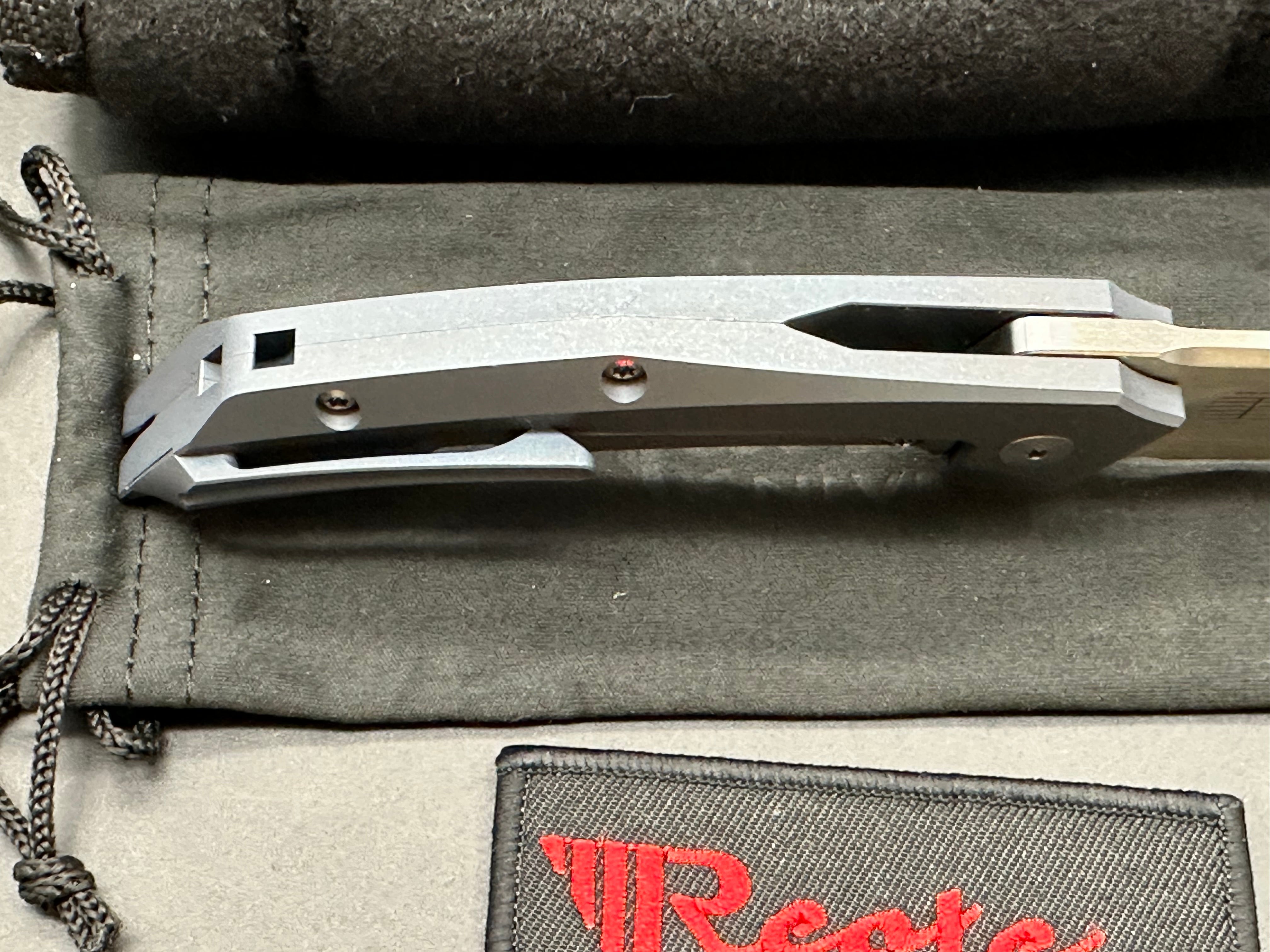 Reate Starboy: Tashi Bharucha design. 3 inch, hand rub, satin, clip point RWL-34 blade. Milled and blue anodized frame