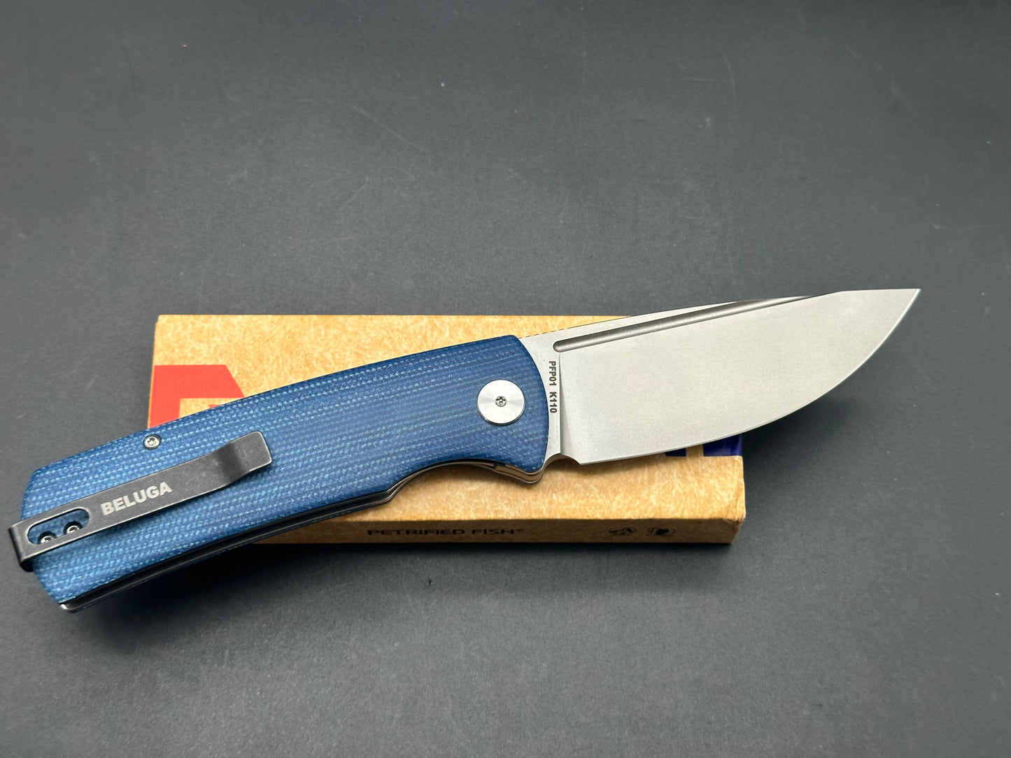 PETRIFIED FISH BELUGA FOLDING KNIFE BLUE MICARTA HANDLE K110 PLAIN EDGE SANDBLASTED FINISH