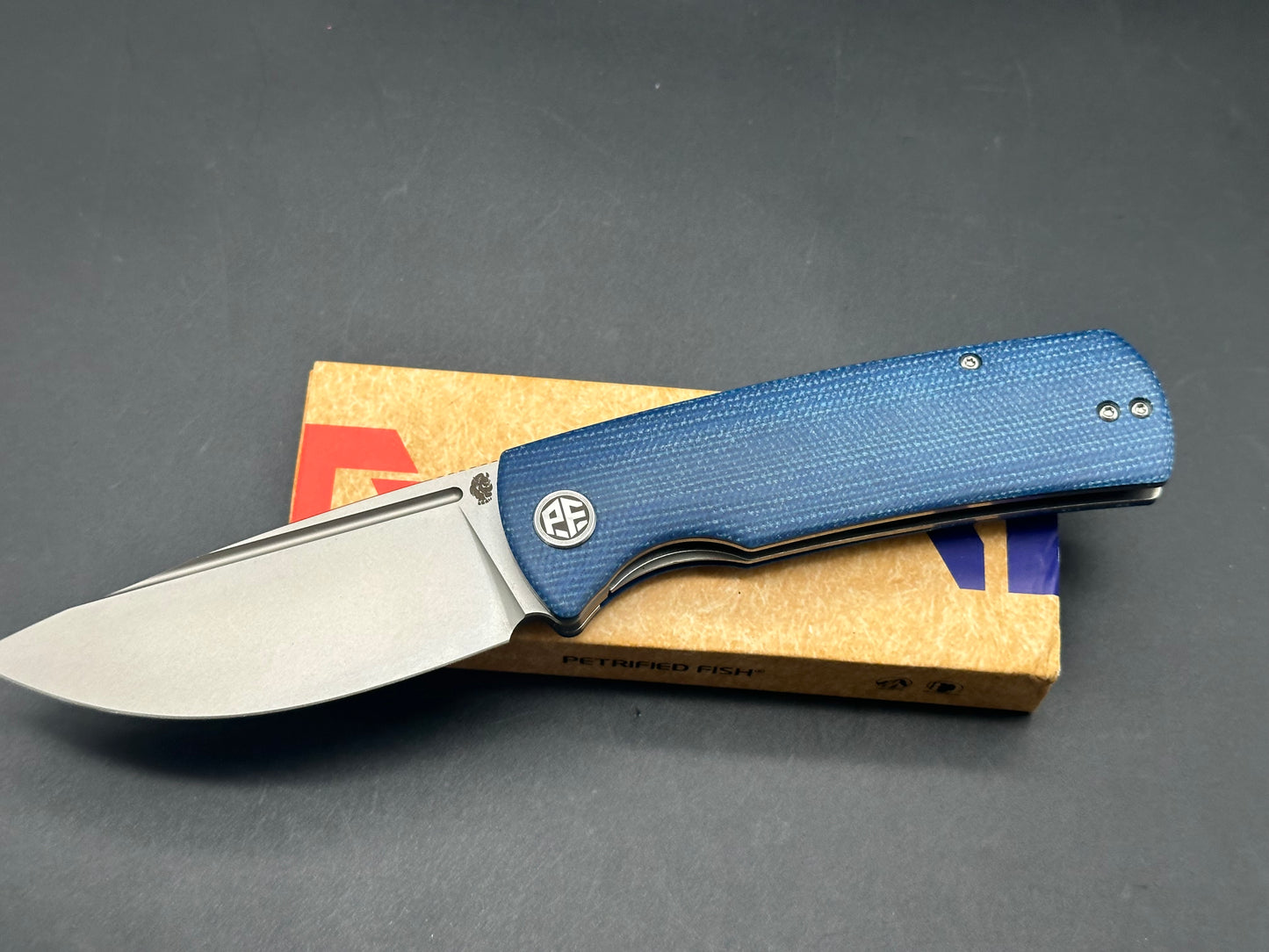 PETRIFIED FISH BELUGA FOLDING KNIFE BLUE MICARTA HANDLE K110 PLAIN EDGE SANDBLASTED FINISH