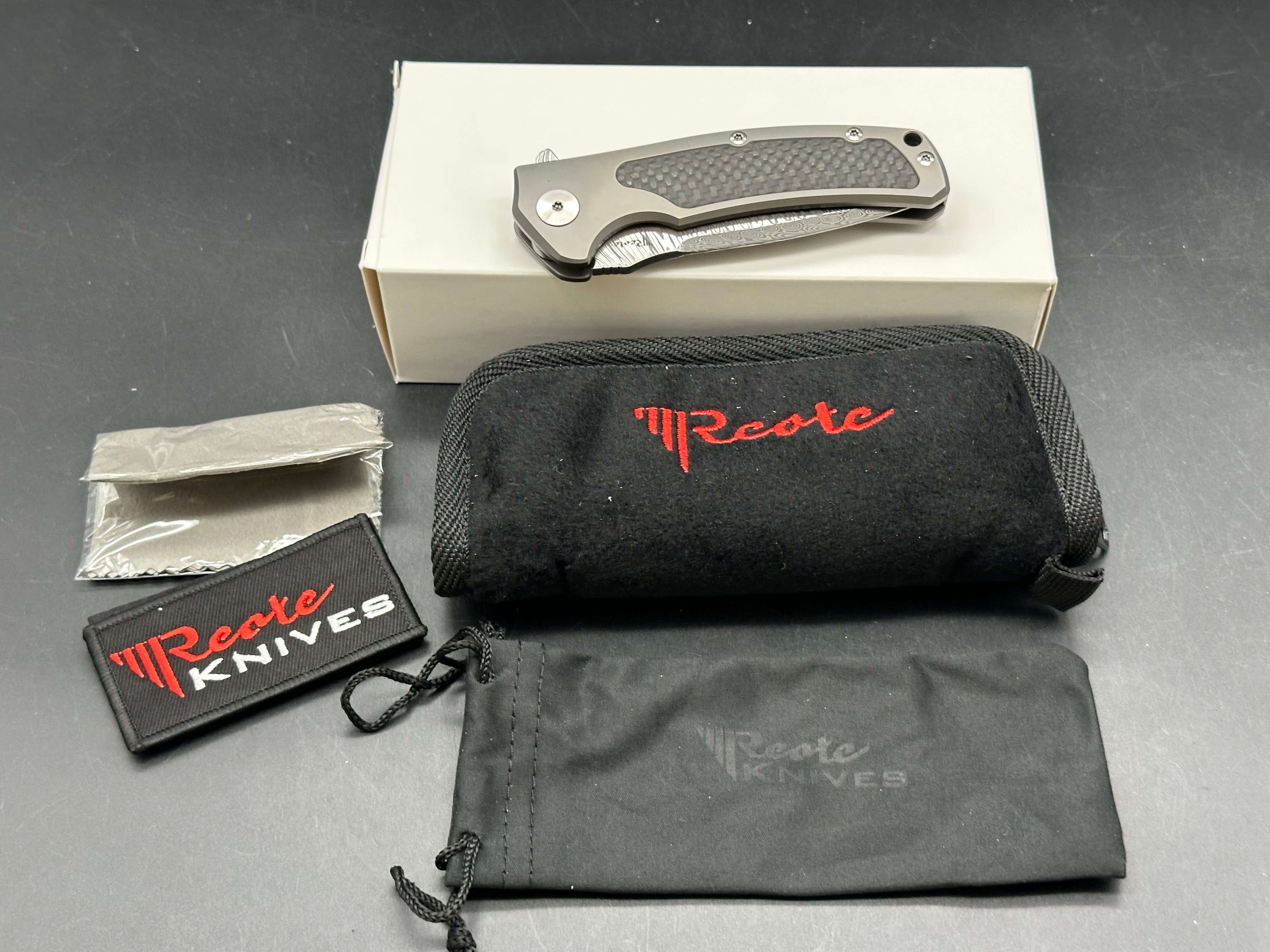 Reate Mini Horizon D: 3.5 inch drop point Damascus blade. 3D machined titanium handle with carbon fiber inlay