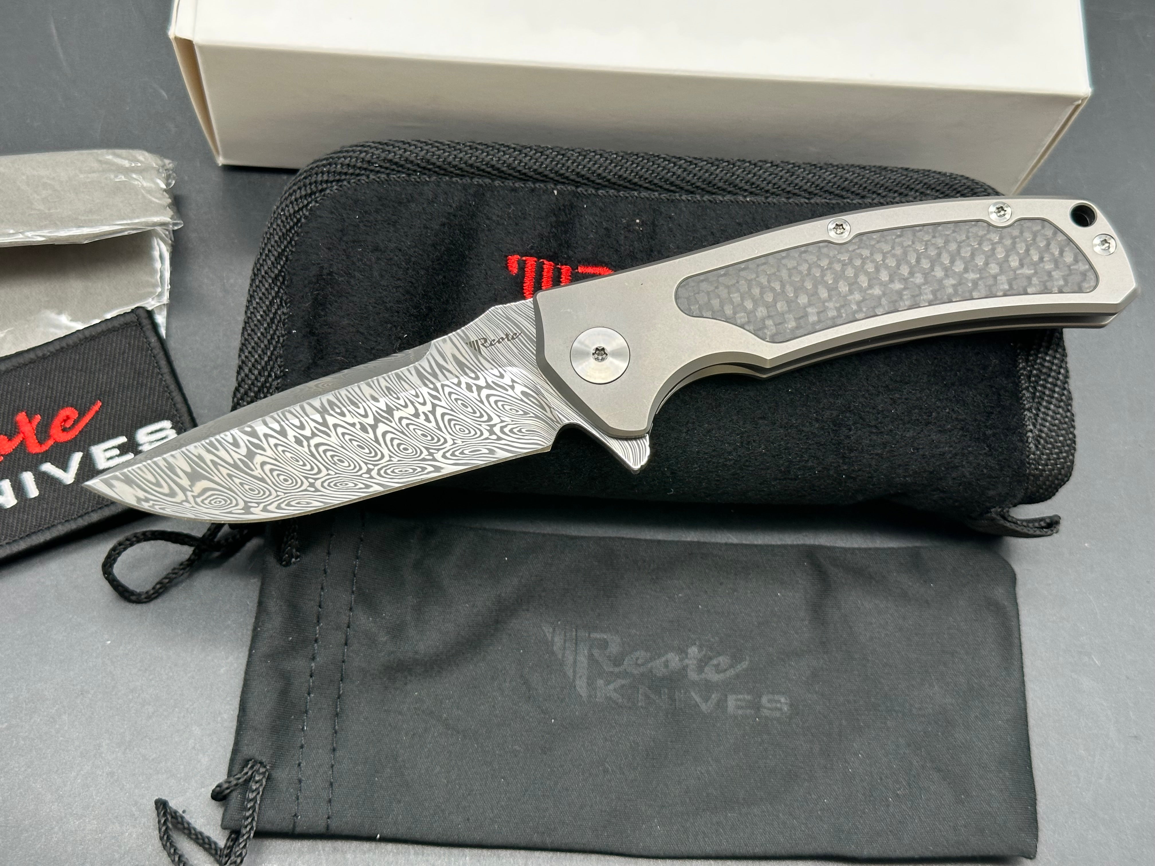 Reate Mini Horizon D: 3.5 inch drop point Damascus blade. 3D machined titanium handle with carbon fiber inlay