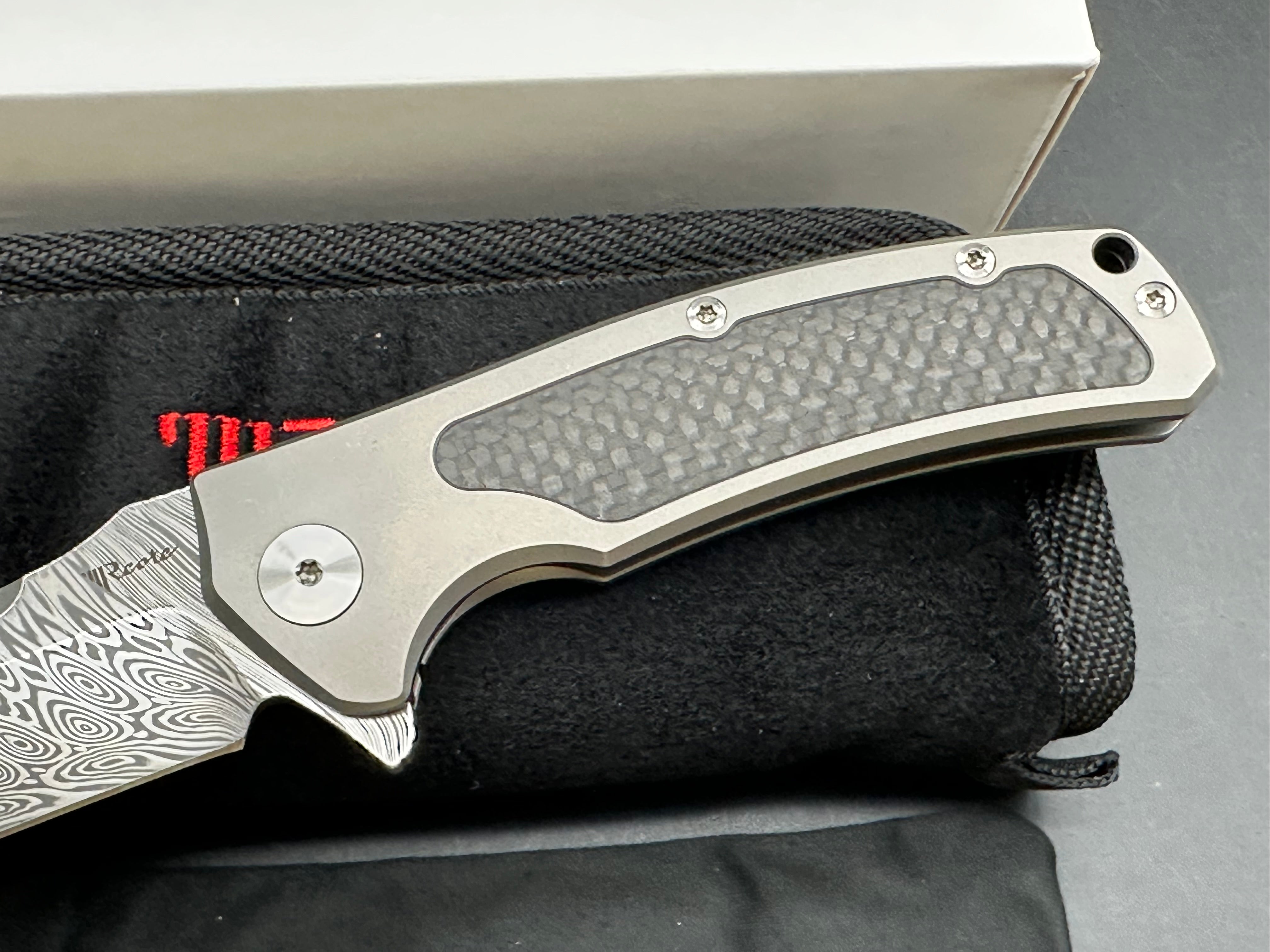 Reate Mini Horizon D: 3.5 inch drop point Damascus blade. 3D machined titanium handle with carbon fiber inlay