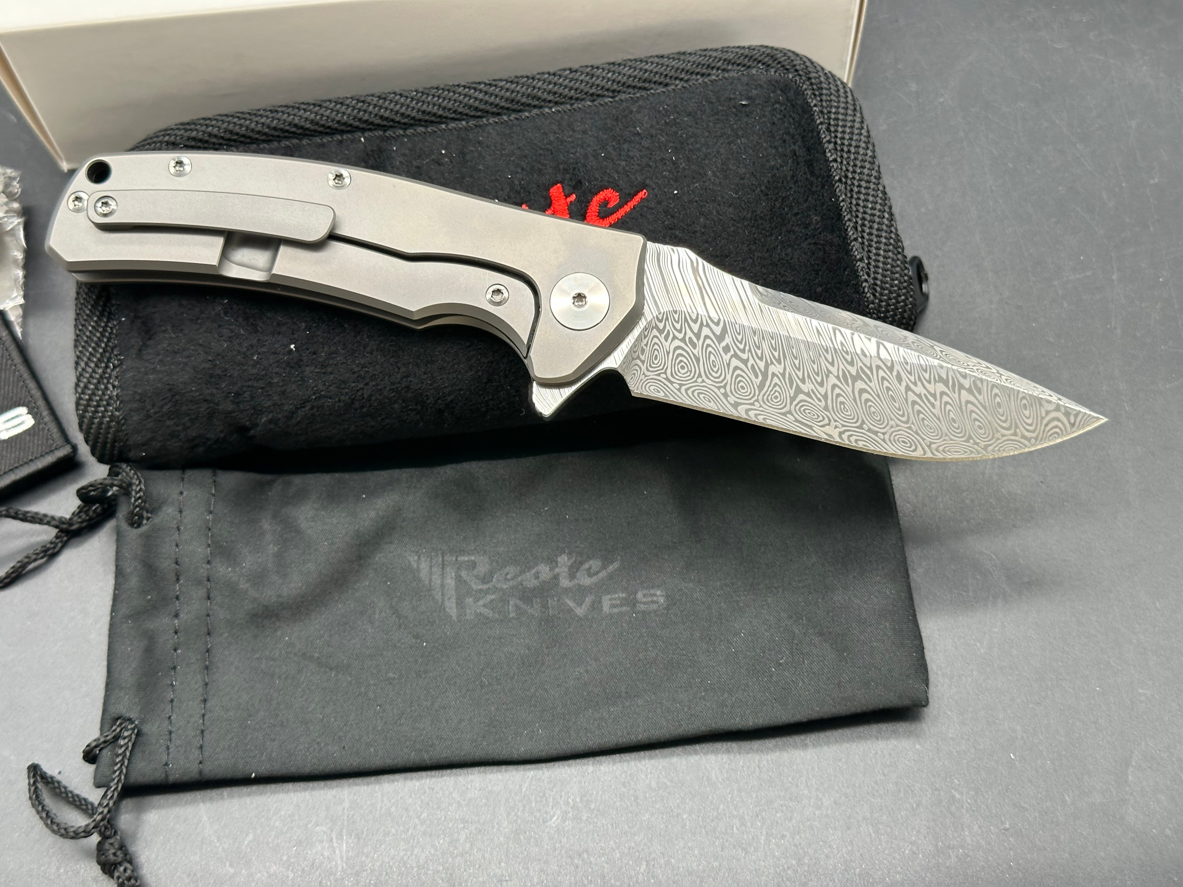Reate Mini Horizon D: 3.5 inch drop point Damascus blade. 3D machined titanium handle with carbon fiber inlay