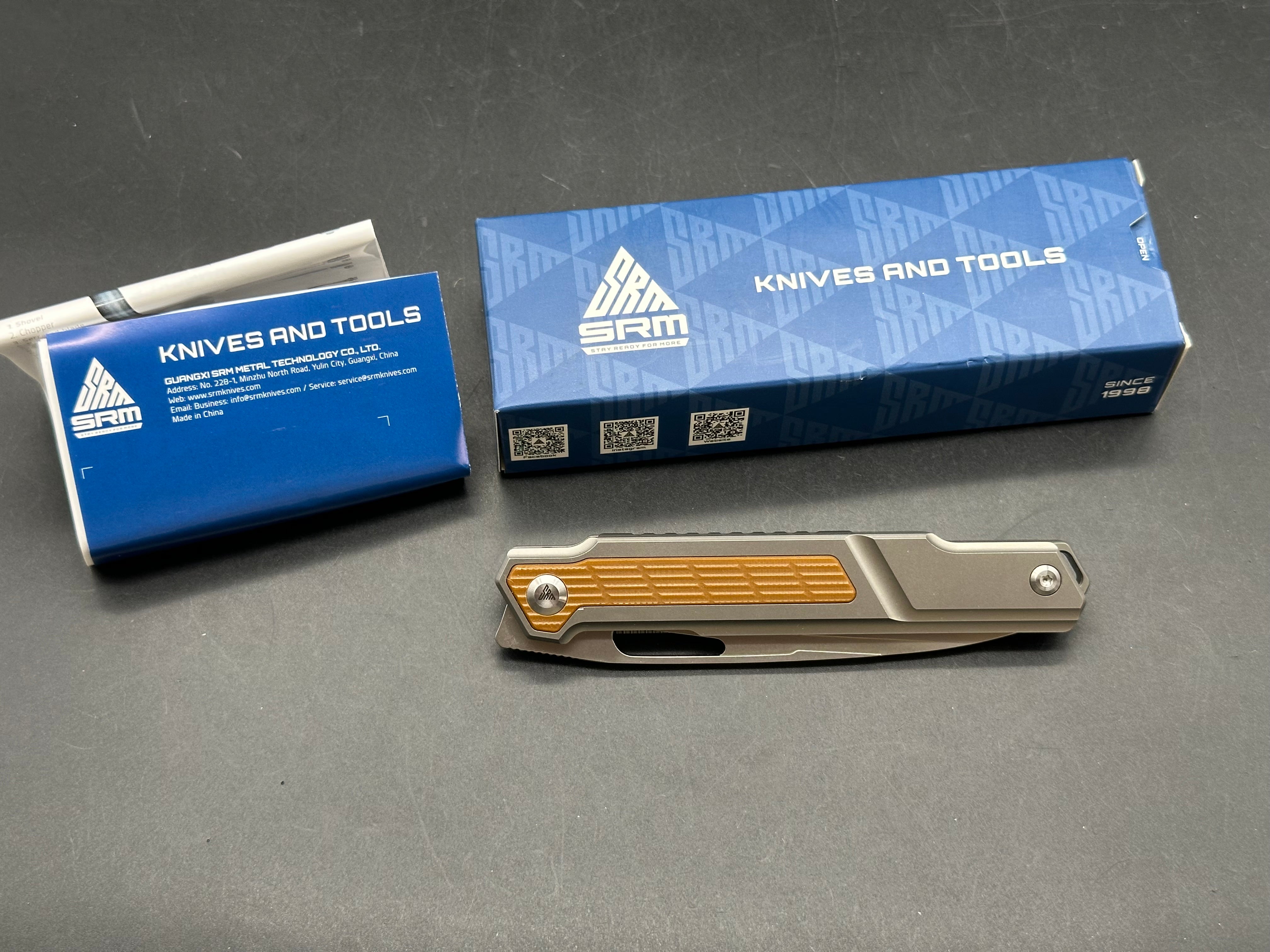 SRM model 1421: 3.63 inch N690 blade. Titanium frame with tan G10 insert