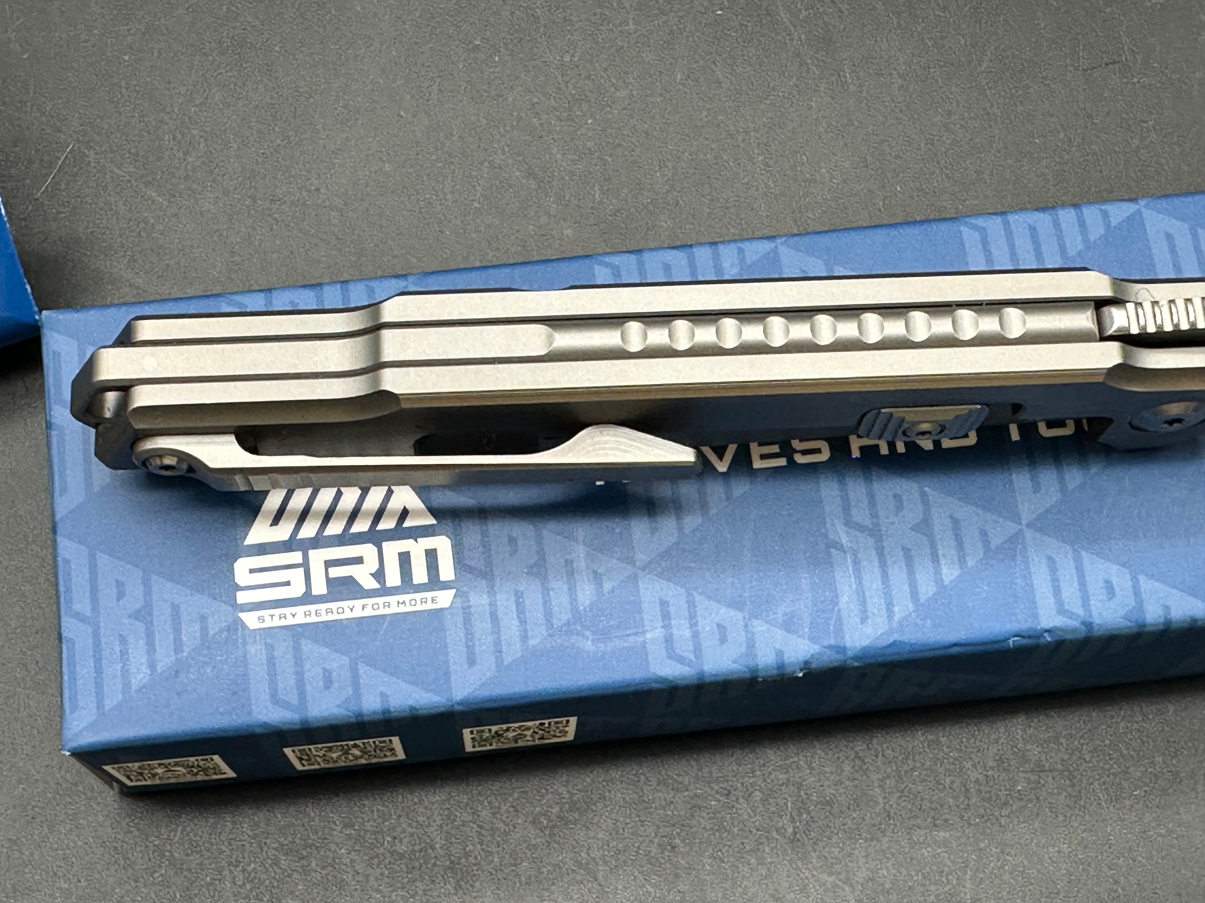SRM model 1421: 3.63 inch N690 blade. Titanium frame with tan G10 insert