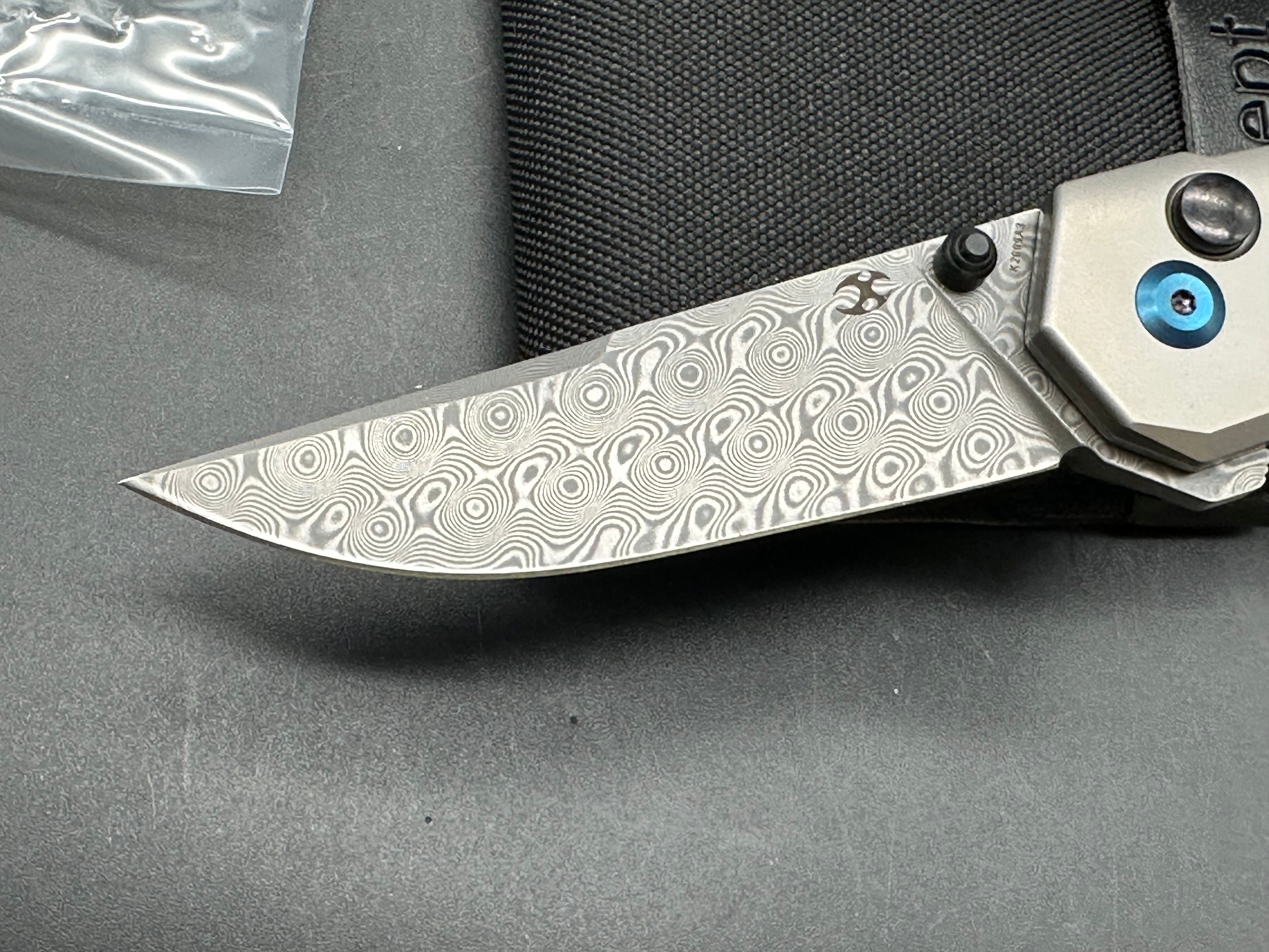 Kansept EDC Tac: Mikkel Willumsen design. 3.1 inch flat grind Damascus blade. Carbon fiber and titanium front and back scales