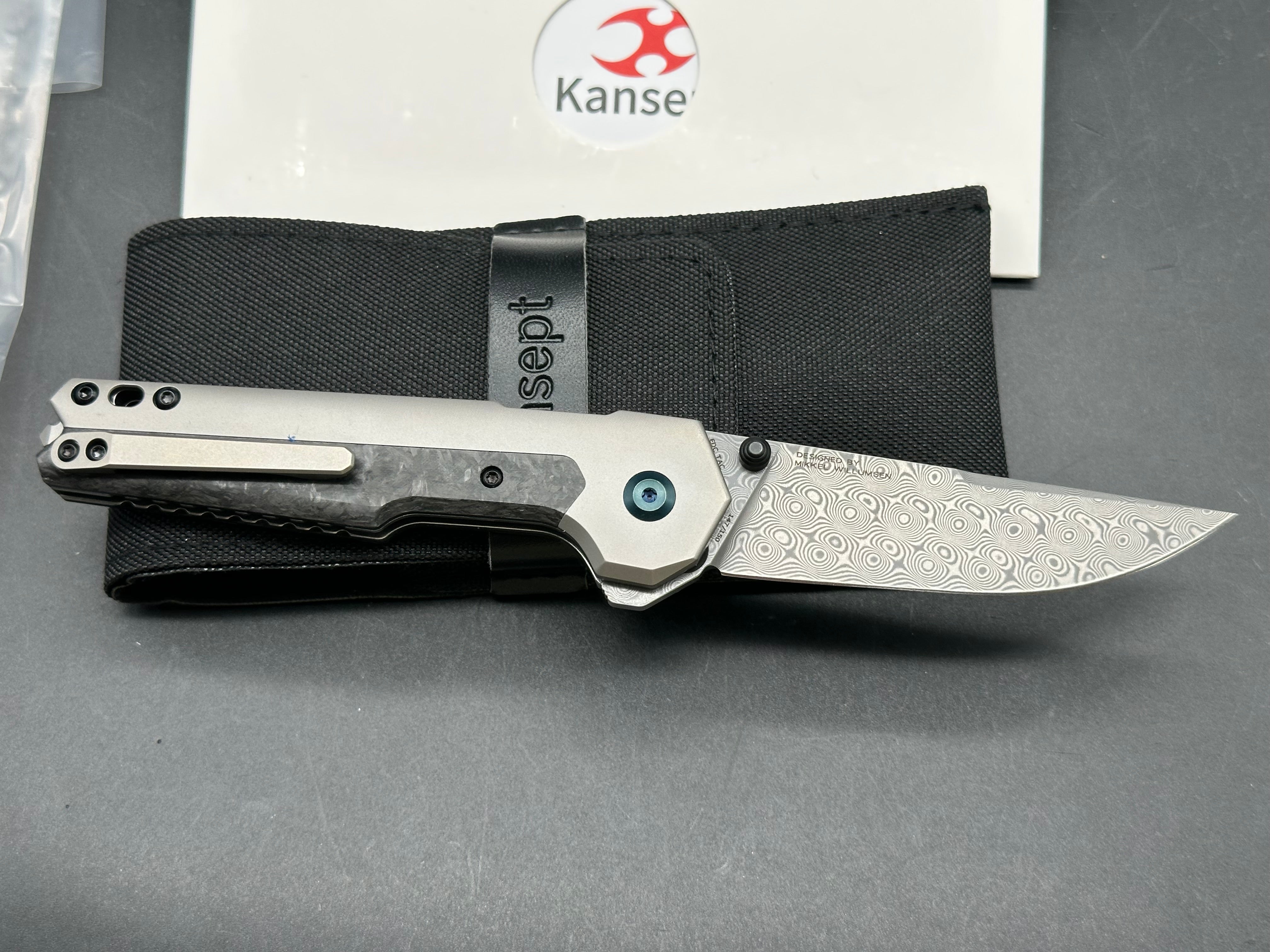 Kansept EDC Tac: Mikkel Willumsen design. 3.1 inch flat grind Damascus blade. Carbon fiber and titanium front and back scales