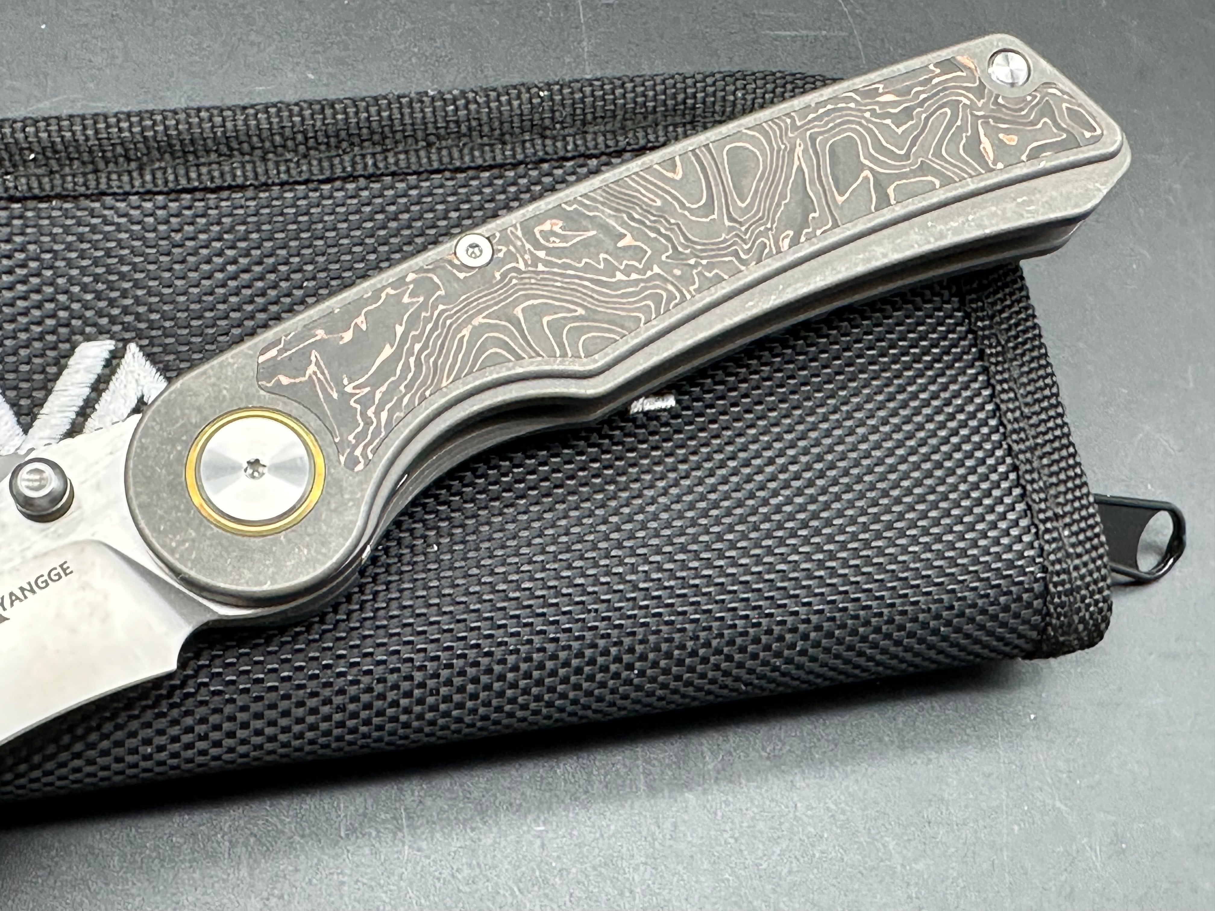 YANGGE FOLDING KNIFE SANDWASHED TITANIUM COPPER FOIL CARBON FIBER HANDLE S90V