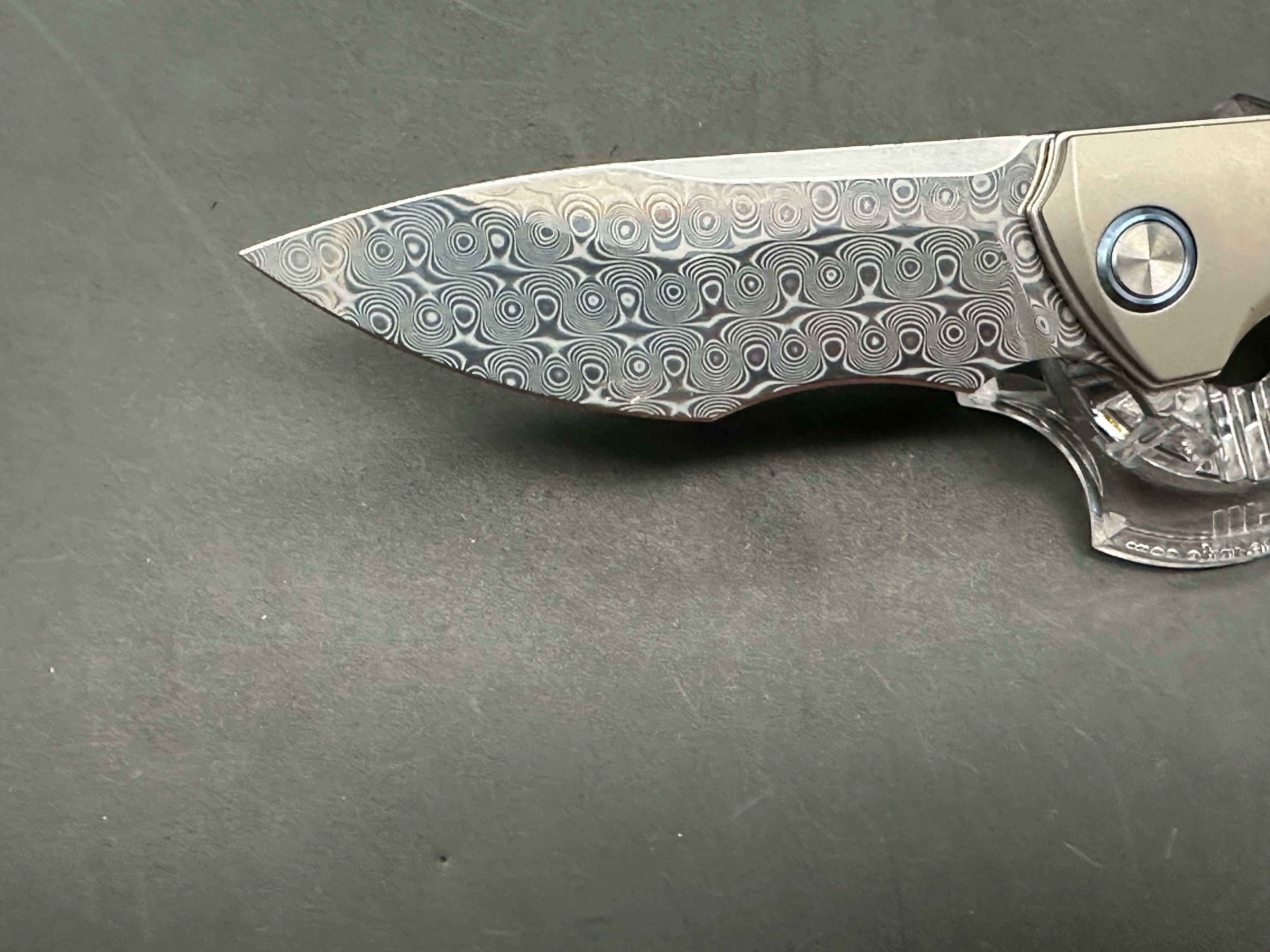 Sitivian ST255 / 3.5 inch polished Damascus blade. Titanium handle with carbon fiber inlays