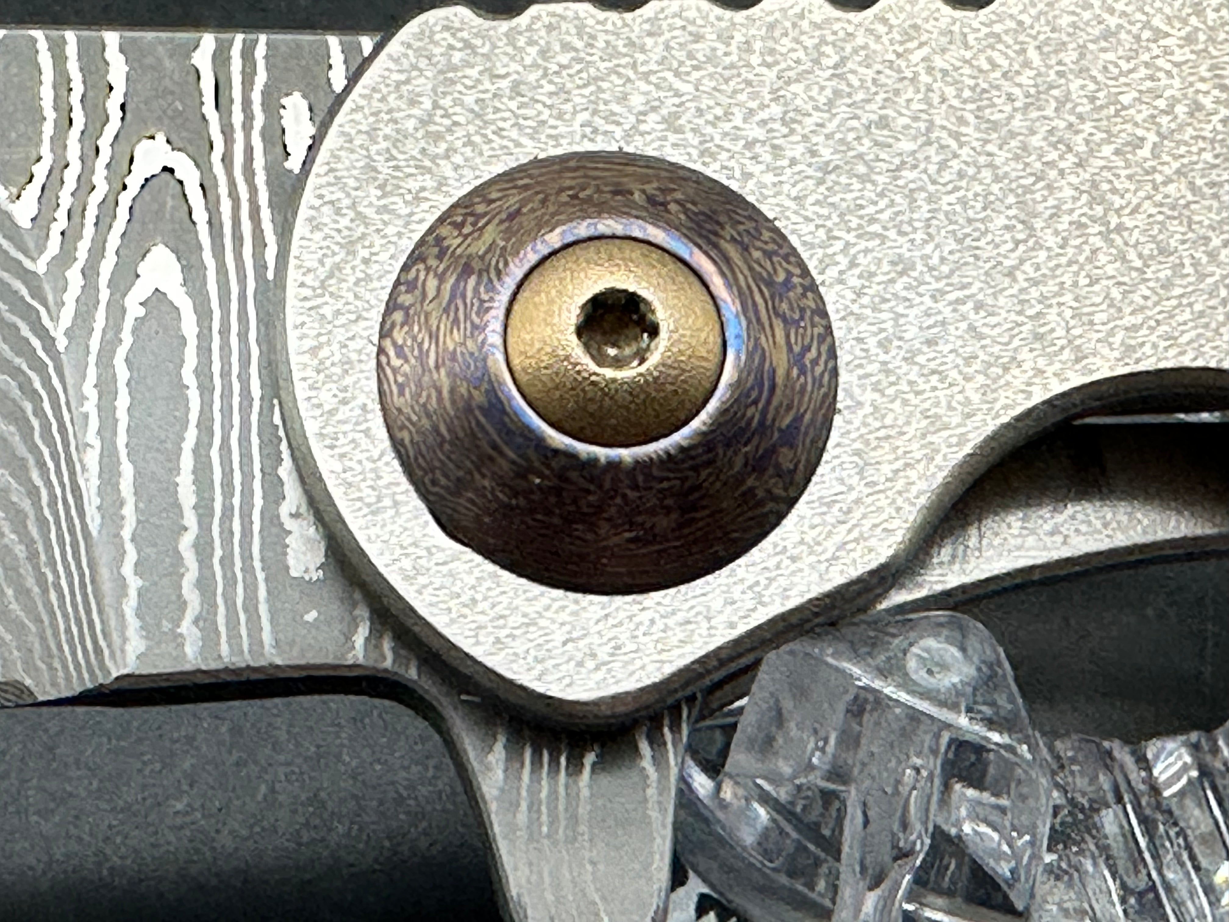 Jurgen Schanz Dress Flipper One-Off: 3.625 inch Damscus blade. Orange peel titanium frame. Mokuti pivot collars