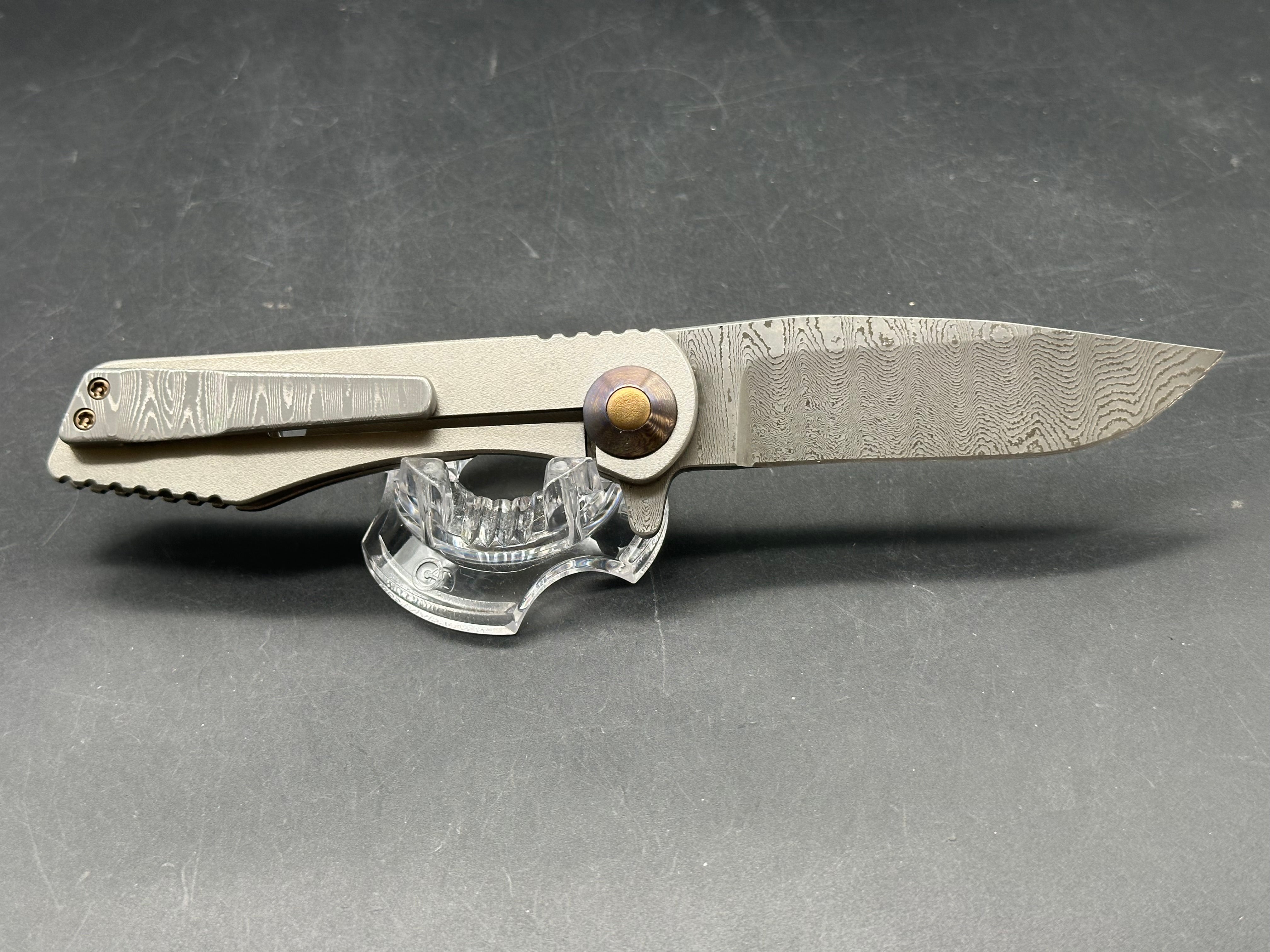 Jurgen Schanz Dress Flipper One-Off: 3.625 inch Damscus blade. Orange peel titanium frame. Mokuti pivot collars
