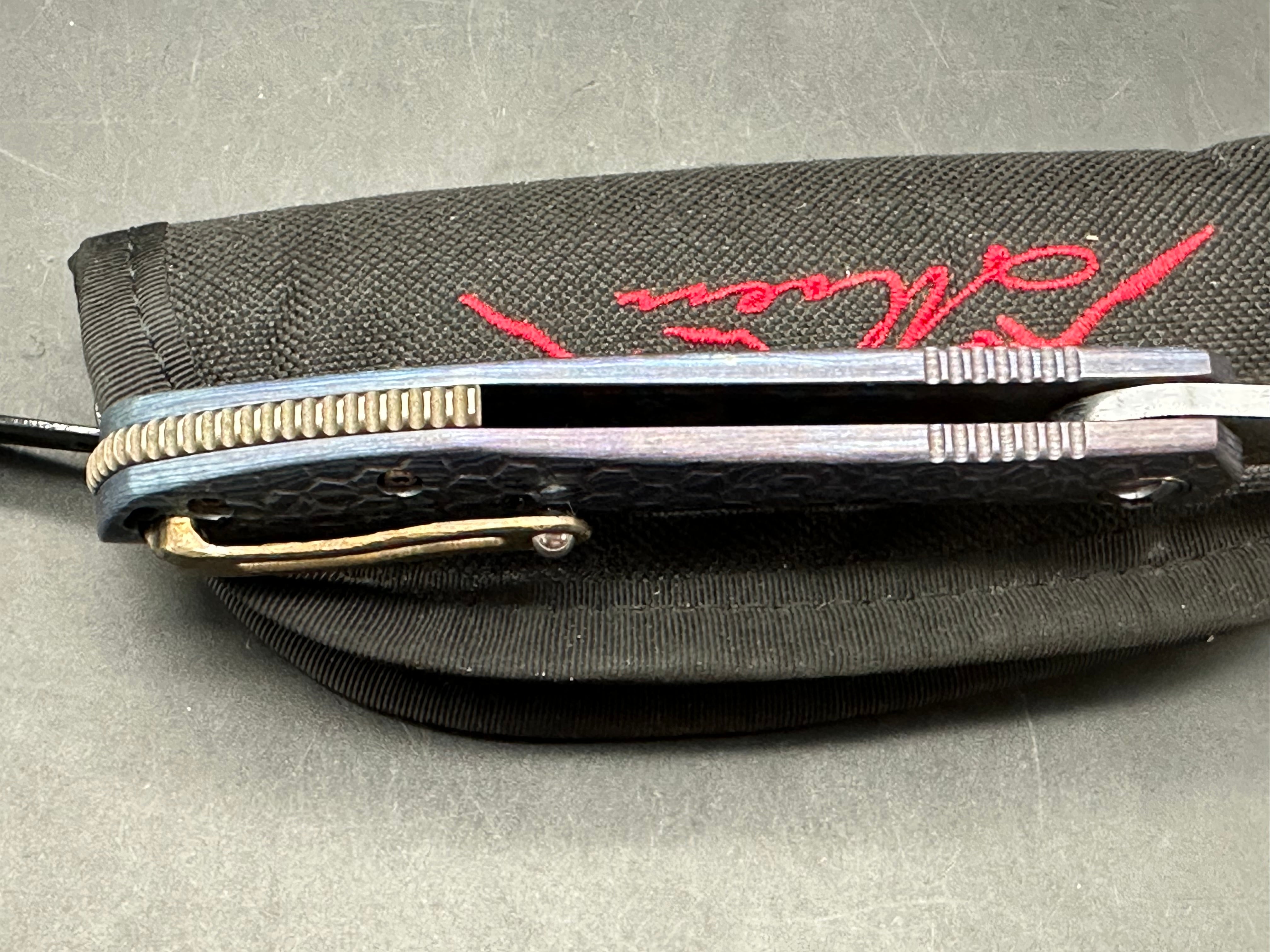 Jerry Moen Mongoose: 3.5 inch Damasteel recurve blade. Milled Mokuti frame with anodized titanium backspacer and clip