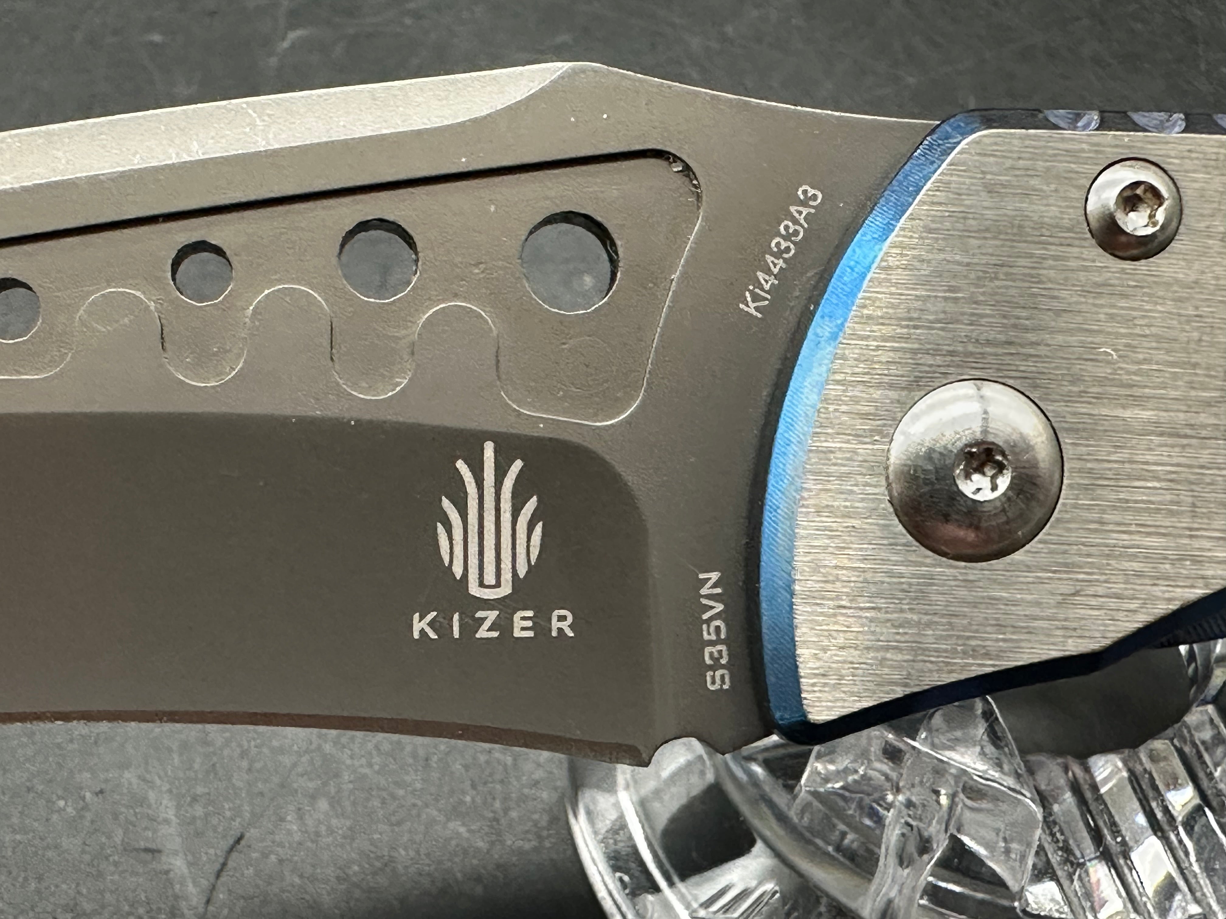 Kizer LGM: 4 inch titanium coated CPM-S35VN blade. Two tone anodized titanium frame