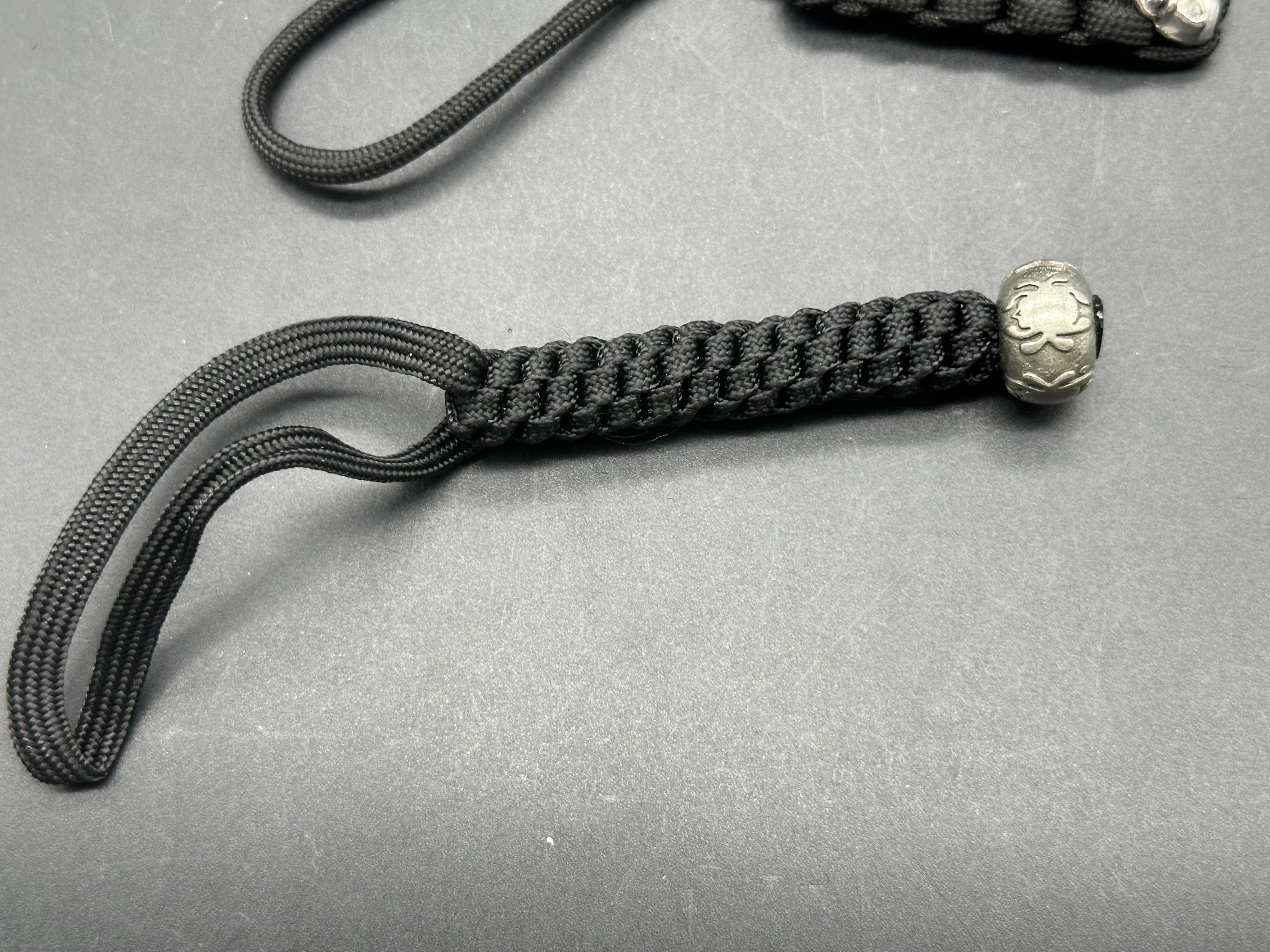 2 - paracord lanyards. Spyderco bead & skull bead