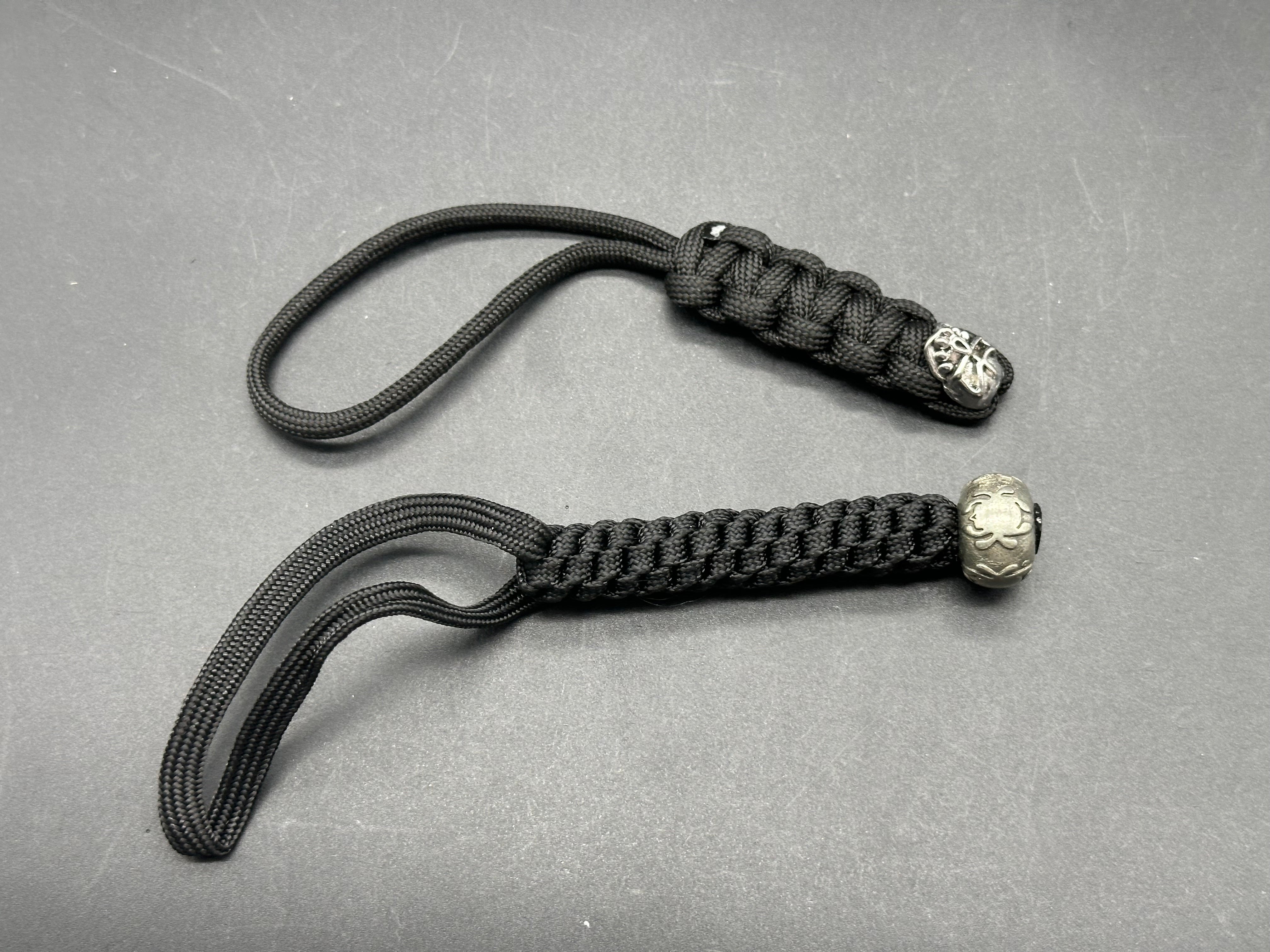 2 - paracord lanyards. Spyderco bead & skull bead